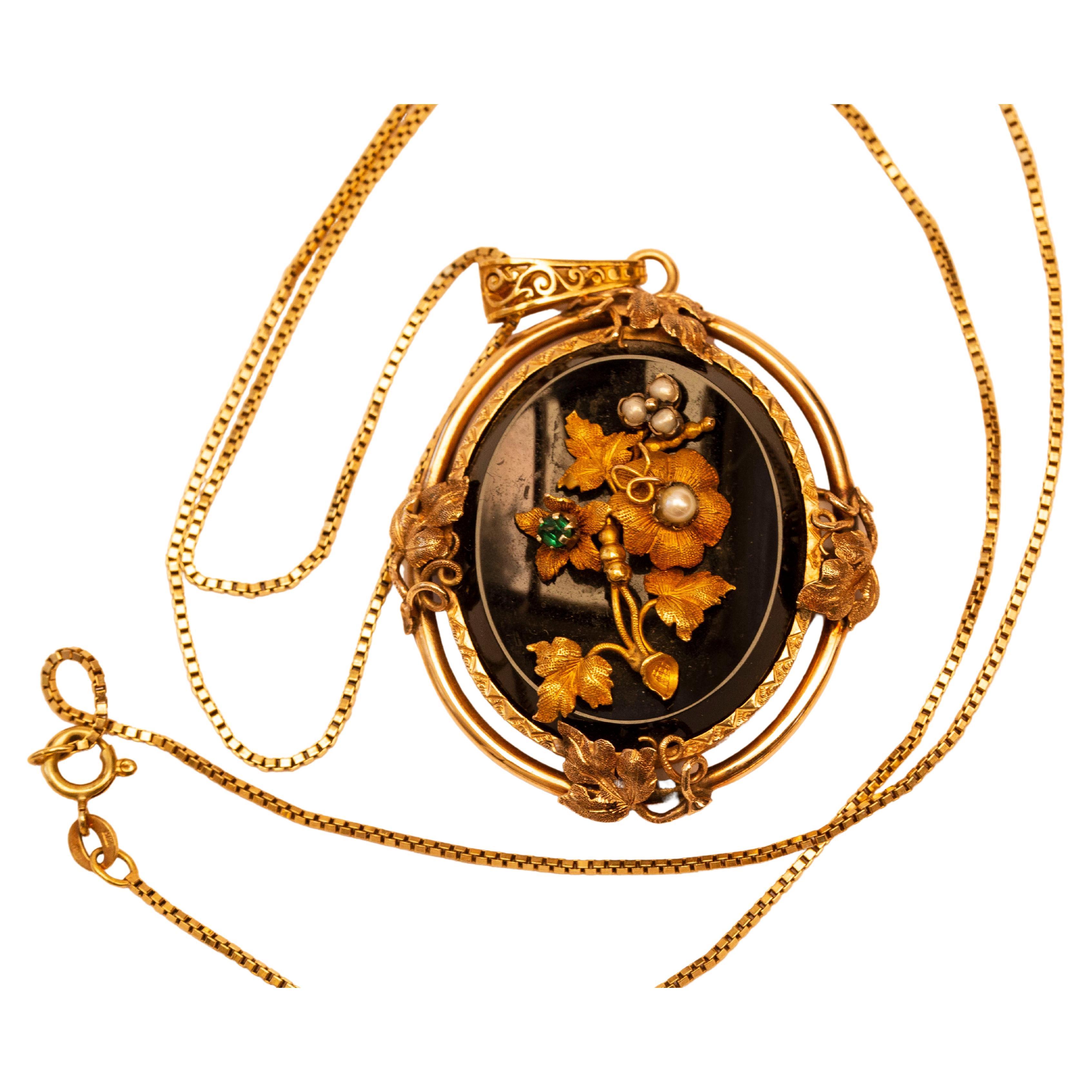 Antique 14 Karat Oval Onyx Pendant with Floral Emerald Pearl & Gold Decoration  For Sale