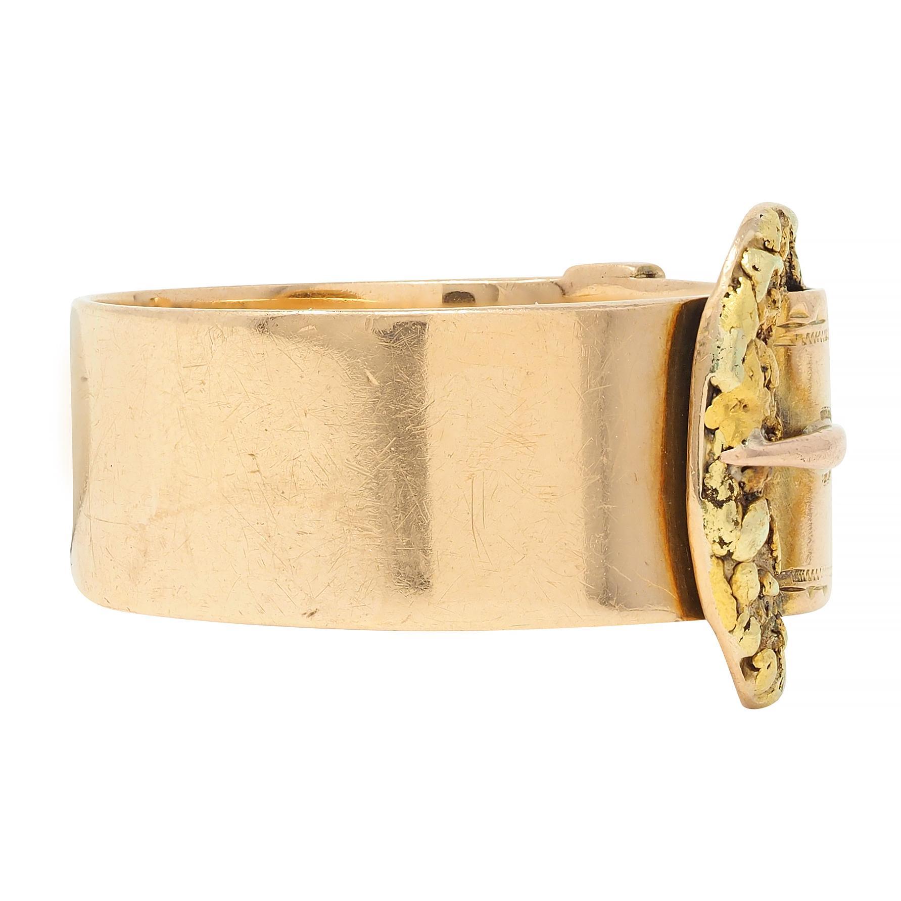 Designed as a wide rose gold band featuring a dimensional buckle motif
Buckle and strap are yellow gold with gold nugget-style texture
Accented by engraved stitch and loop motif detailing 
Stamped for 14 karat gold
With maker's mark for Jos. Mayers