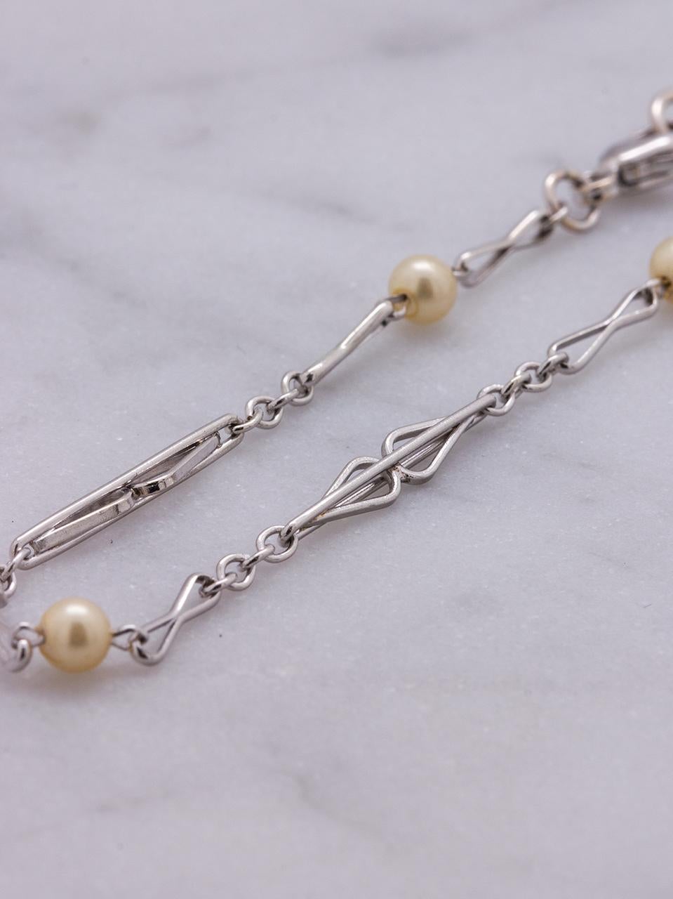 This dainty, feminine antique chain bracelet features four x 3mm off-white round pearls and elongated chain link is beautiful worn alone or layerd with other bracelets or even a wristwatch. The bracelet measures approximately 3mm wide and is secured
