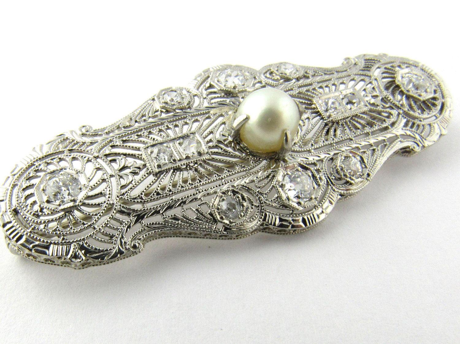 Antique 14K White Gold Diamond and Pearl Filagree Pendant Brooch 

This absolutely stunning and sparkling diamond pendant can also be worn as a brooch. It is the perfect piece to adorn that fancy dress for a special occasion. 

This pendant/brooch