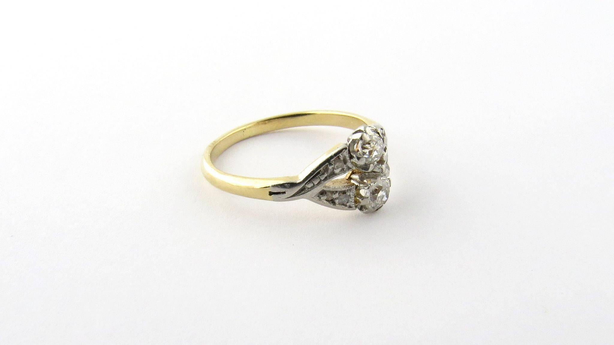 Antique 14K Gold and Diamond Ring Size 4.75 

This dainty antique ring is set with two old mine stones each approximately .10 cts. I1 clarity, M color 

There are 8 small rose cut diamonds set on the sides of the center diamonds. 

This ring was