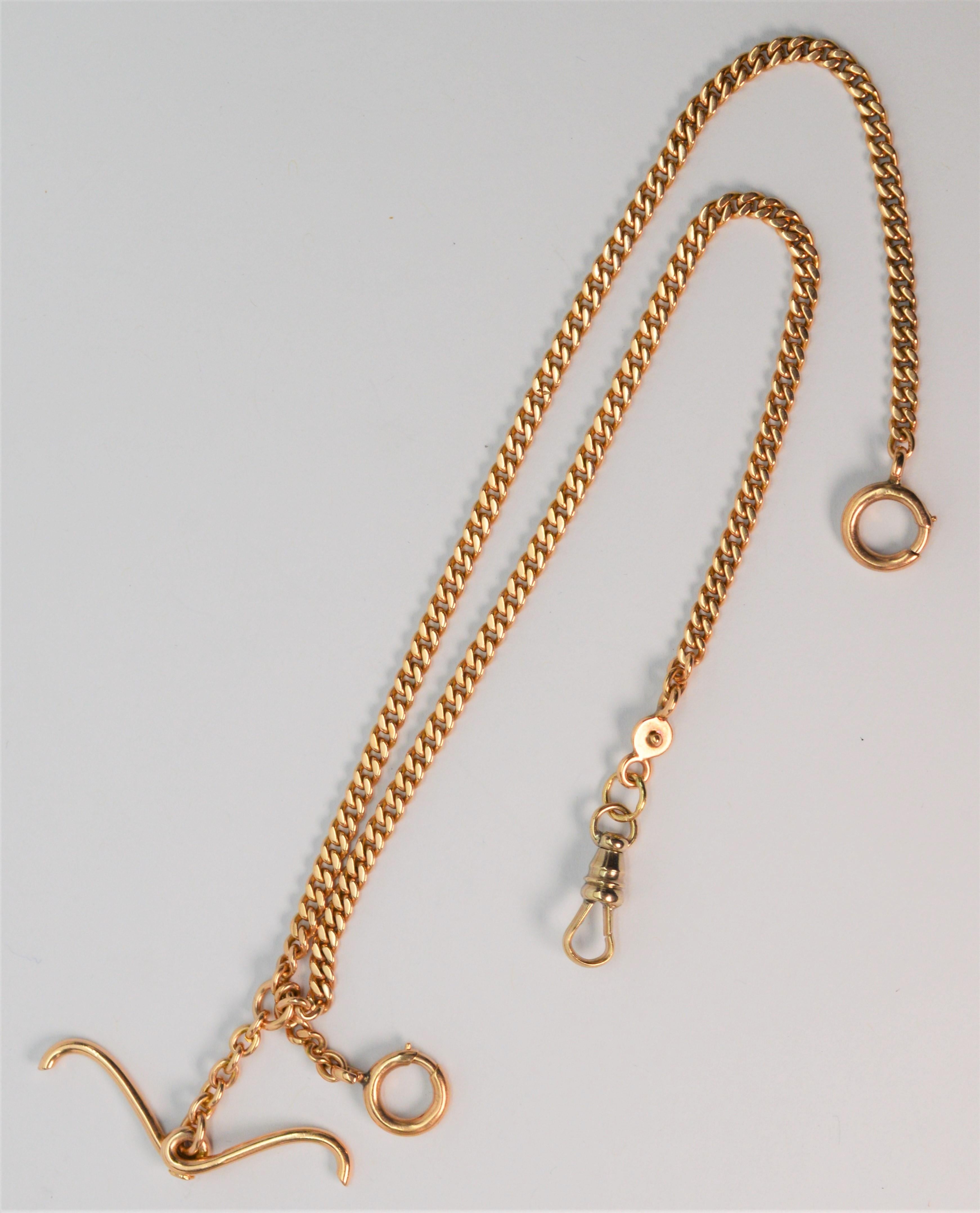 In 14 Karat yellow gold, this antique watch chain is nicely fitted with a fancy T bar, dog clip and double fob chains with spring ring closures. From the T bar, the length of chain to the dog clip is 8.75 inches. From the T bar the longer length of