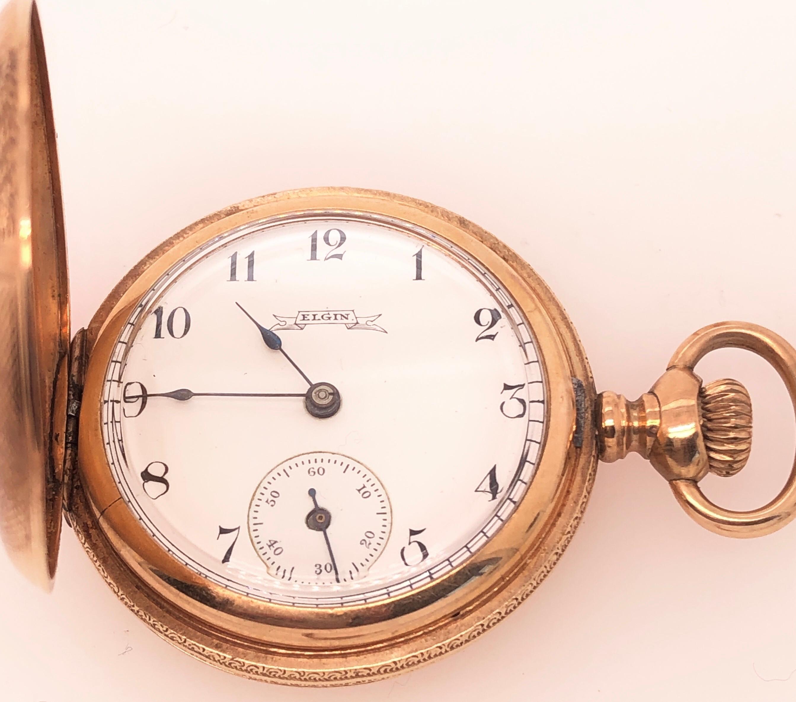 Antike Elgin Taschenuhr 14K Gelbgold Taschenuhr, Vorder-und Rückseite des Gehäuses sind aufwendig graviert. Weißes Emaille-Zifferblatt mit schwarzen arabischen Ziffern. Dies ist eine außergewöhnlich gut erhaltene Vintage-Taschenuhr. 34 mm