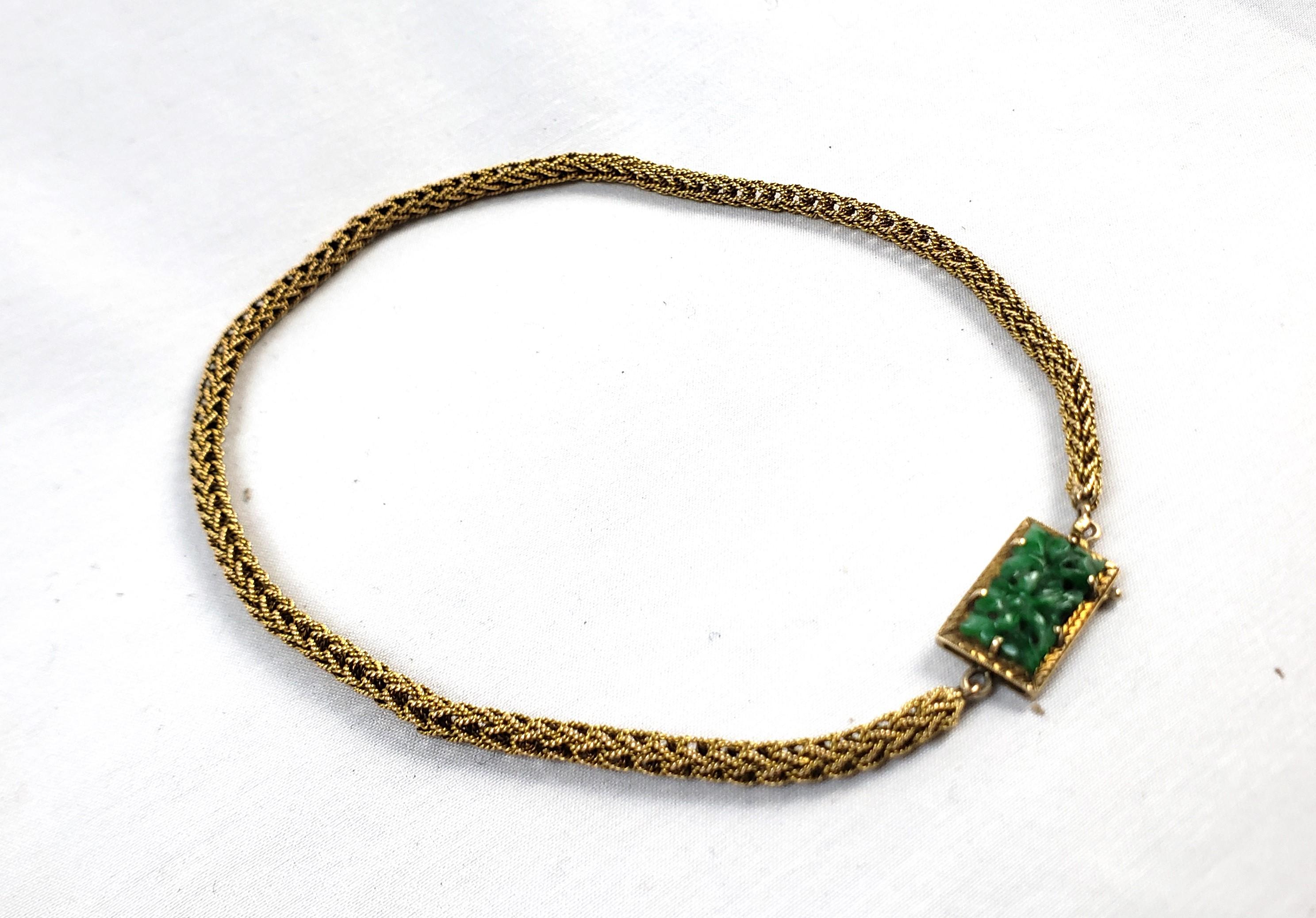 This antique women's necklace is unsigned and unmarked but dates to approximately 1900 and presumed to originate from China and done in a period Chinoiserie style. The necklace is composed of 14 karat yellow gold with a thick robe chain and features