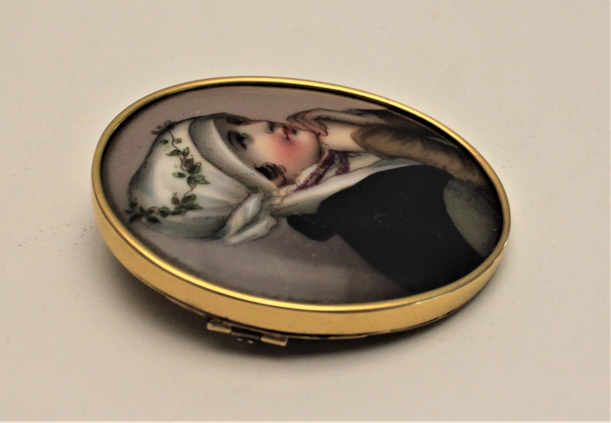 This large antique cameo brooch is presumed to have been made in Italy in approximately the Victorian period. The bezel is unmarked but tests for 14-karat gold. The hand painted porcelain depicts a portrait of a young woman and is quite detailed and