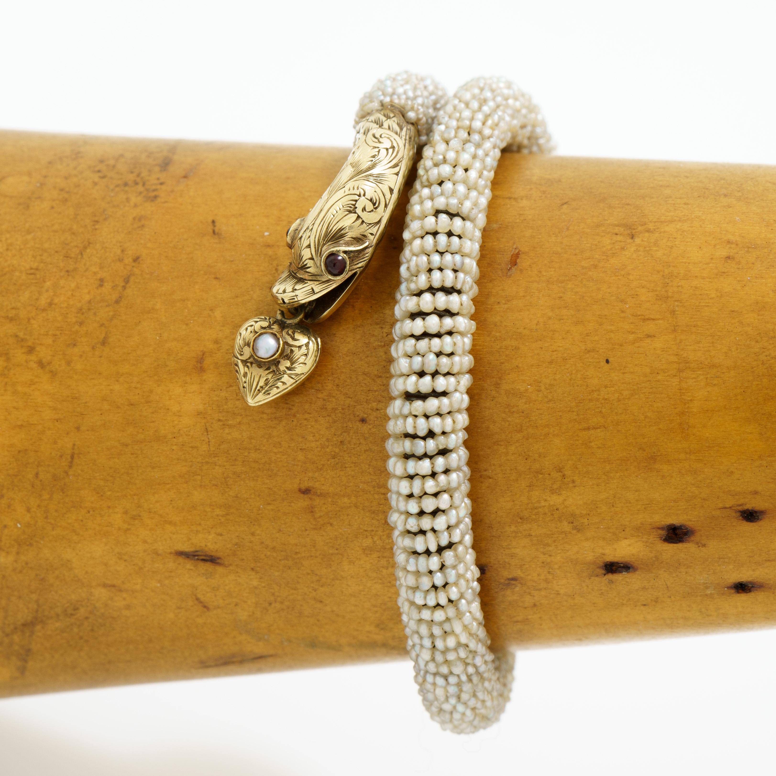 Antique 14 Karat Yellow Gold and Seed Pearl Snake Wrap Bracelet with Heart Locket 
c.1880

Snake head:
Width with Heart  8.1mm
Head Length: 27.13
Tail Tip Length: 14.2mm
Overall length: 230mm

18.55 grams
fits up to a size 6.5 wrist