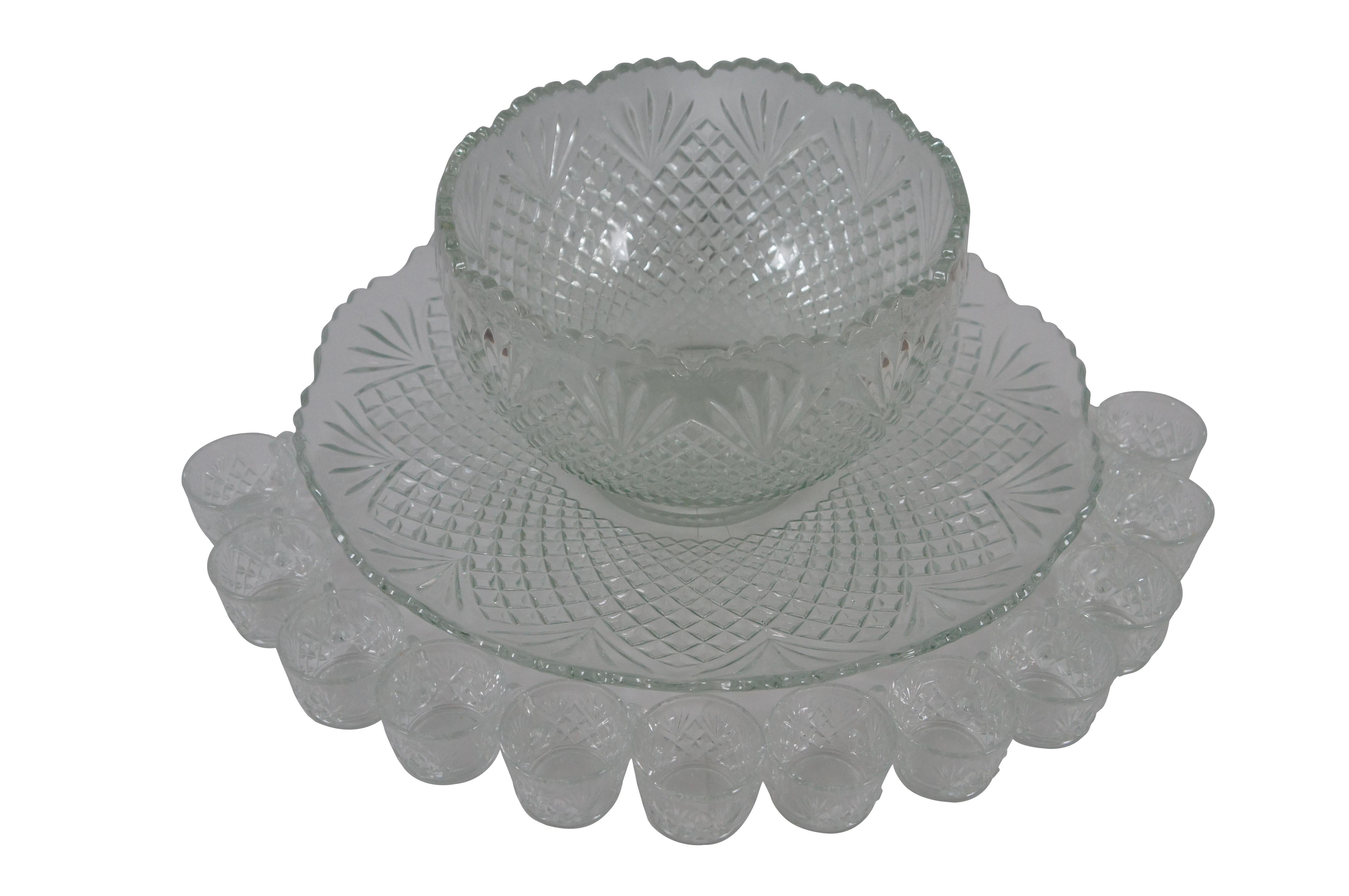 Circa 1940s pressed glass punch set attributed to L.E. Smith Glass Company in the Pineapple pattern. Includes bowl, underplate, and 12 cups. 


