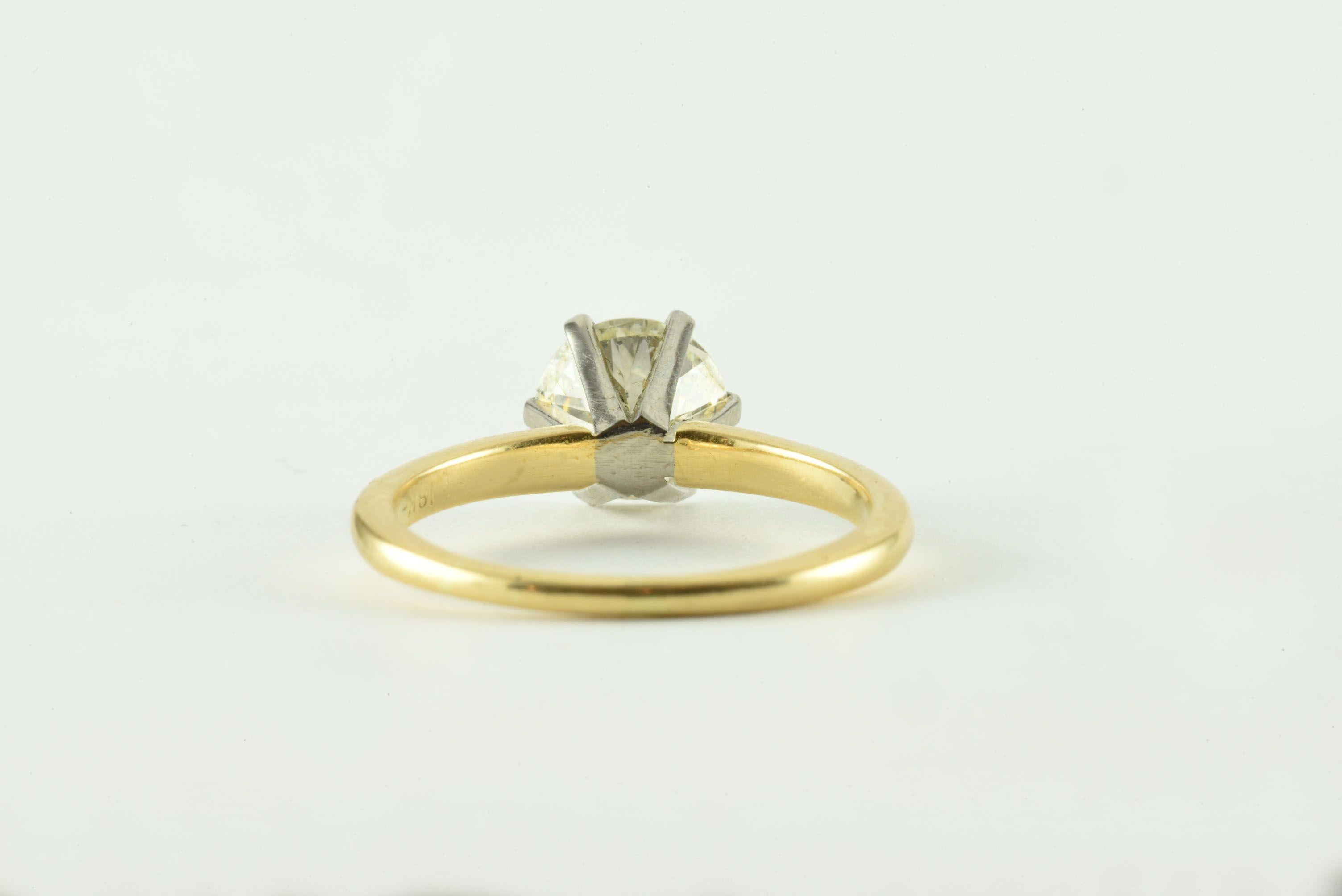 This classic solitaire engagement ring features a stunning Old European cut diamond weighing 1.40 carats, L-M color, SI1 clarity, measuring 7.02 x 7.13 x 4.35mm mounted in a six prong platinum head and a 14kt-18kt yellow gold band. 
