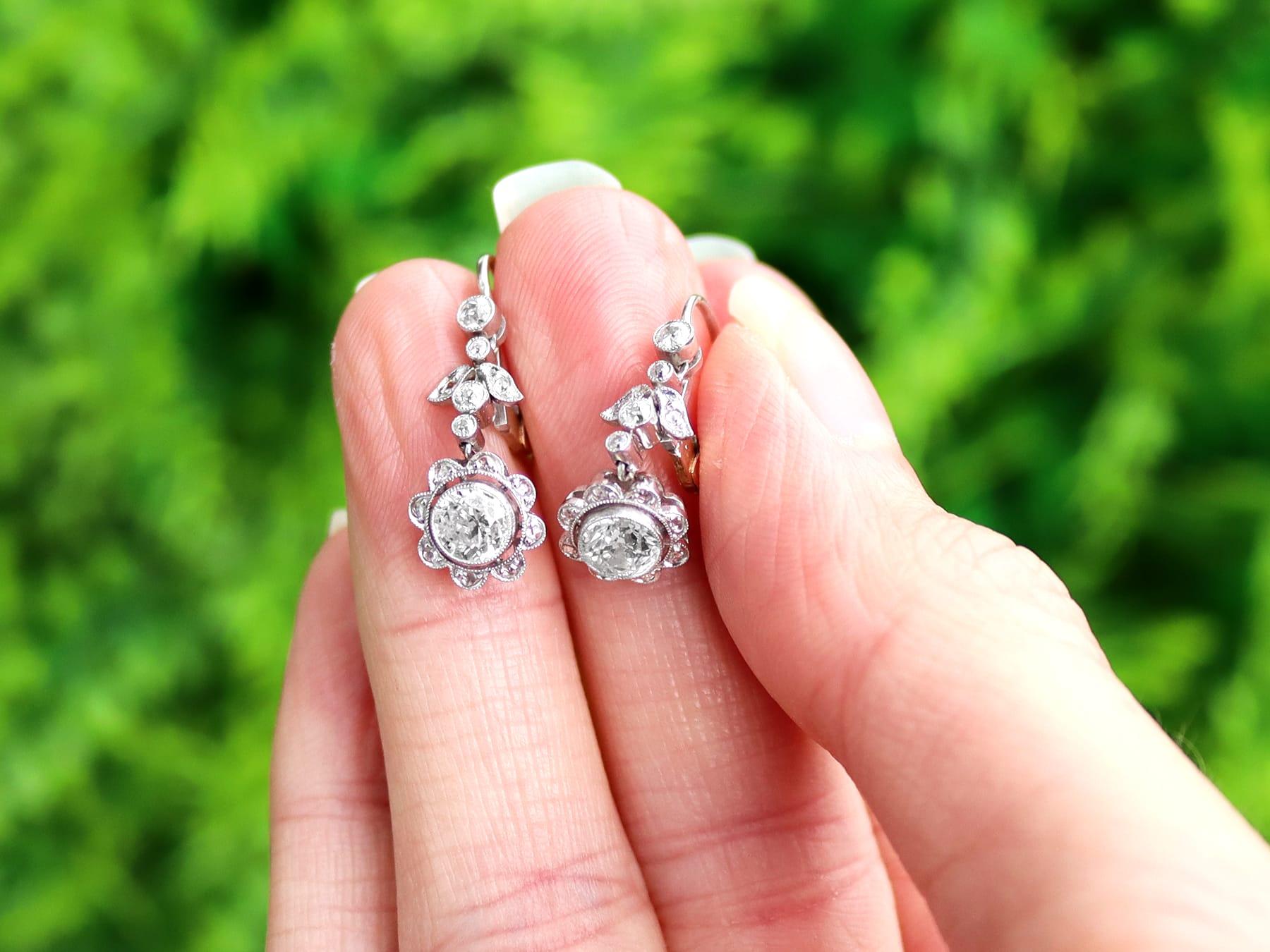 A stunning, fine and impressive pair of antique 1.42 carat diamond, platinum and 15 karat yellow gold drop earrings; part of our diverse antique jewelry collections.

These fine and impressive antique drop earrings have been crafted in
