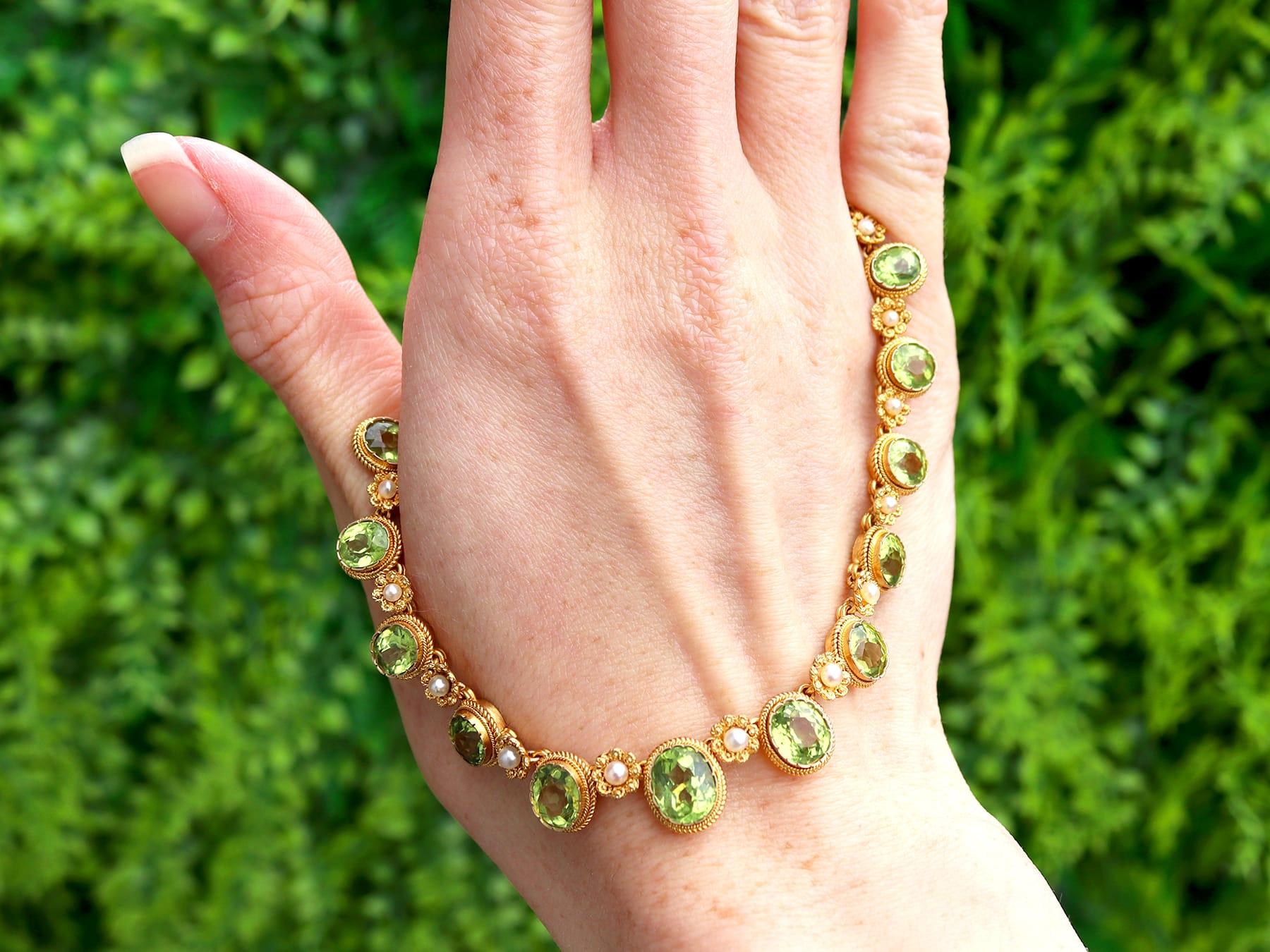 A stunning, fine and impressive antique 14.50 carat peridot and pearl, 18 karat yellow gold necklace; part of our diverse antique peridot jewelry and estate jewelry collections.

This stunning, fine and impressive antique necklace has been crafted