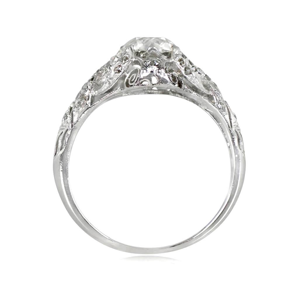 This antique engagement ring from circa 1915 features a 1.48-carat old European cut diamond (K color, VS2 clarity) in prong setting with four leaf-shaped prongs adorned with single cut diamonds. The shoulders showcase a ribbon design with old