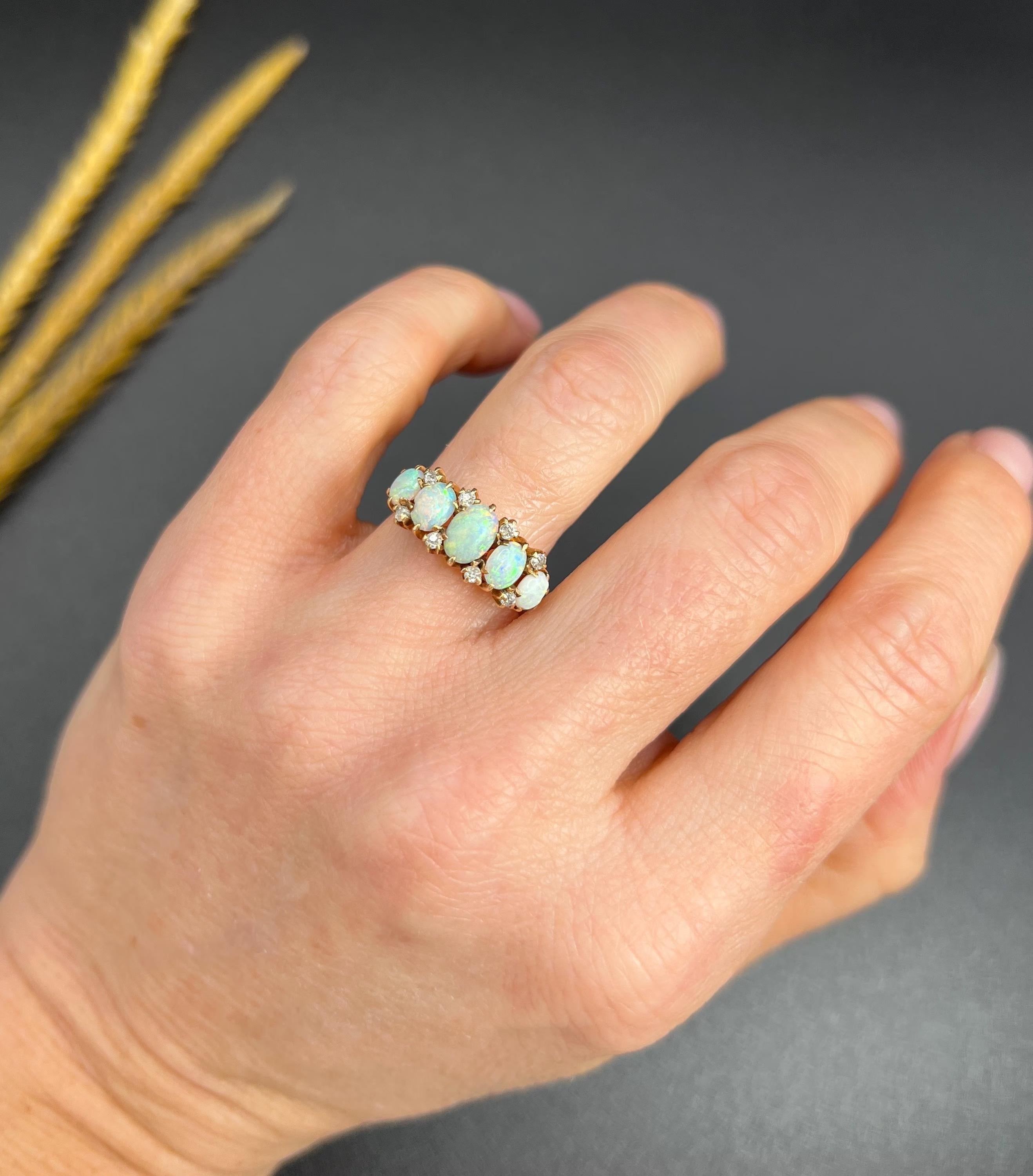 Antique Opal Ring 

14ct Gold

Circa 1920s

This exquisite antique ring, crafted in the 1920s, showcases a captivating arrangement of five oval-shaped fiery opals, elegantly interspersed with delicate natural diamonds. Each opal radiates a