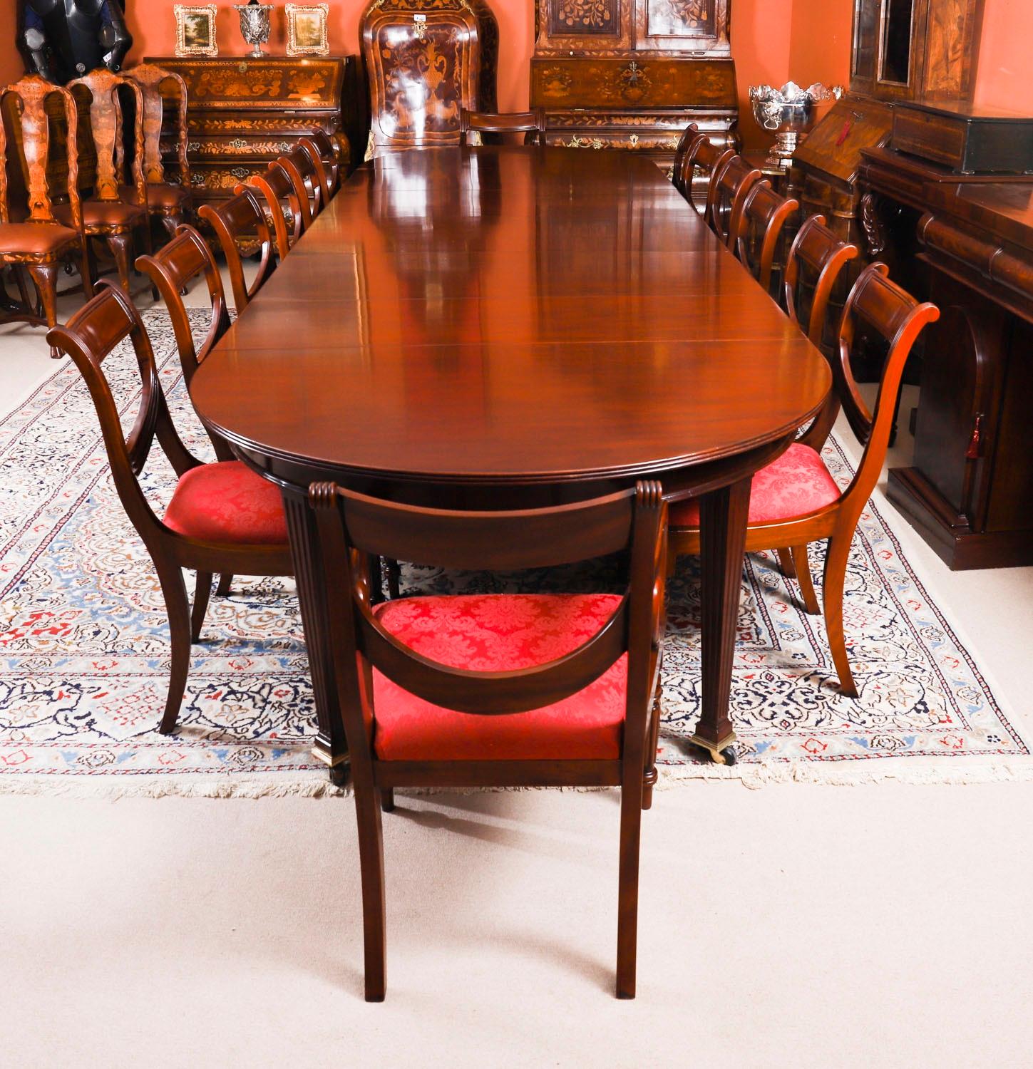 This is a discerning antique late Victorian telescopic extending dining table, circa 1890 in date with  a set of fourteen Regency revival dining chairs.

The table has five original leaves, can comfortably seat fourteen and has been hand-crafted