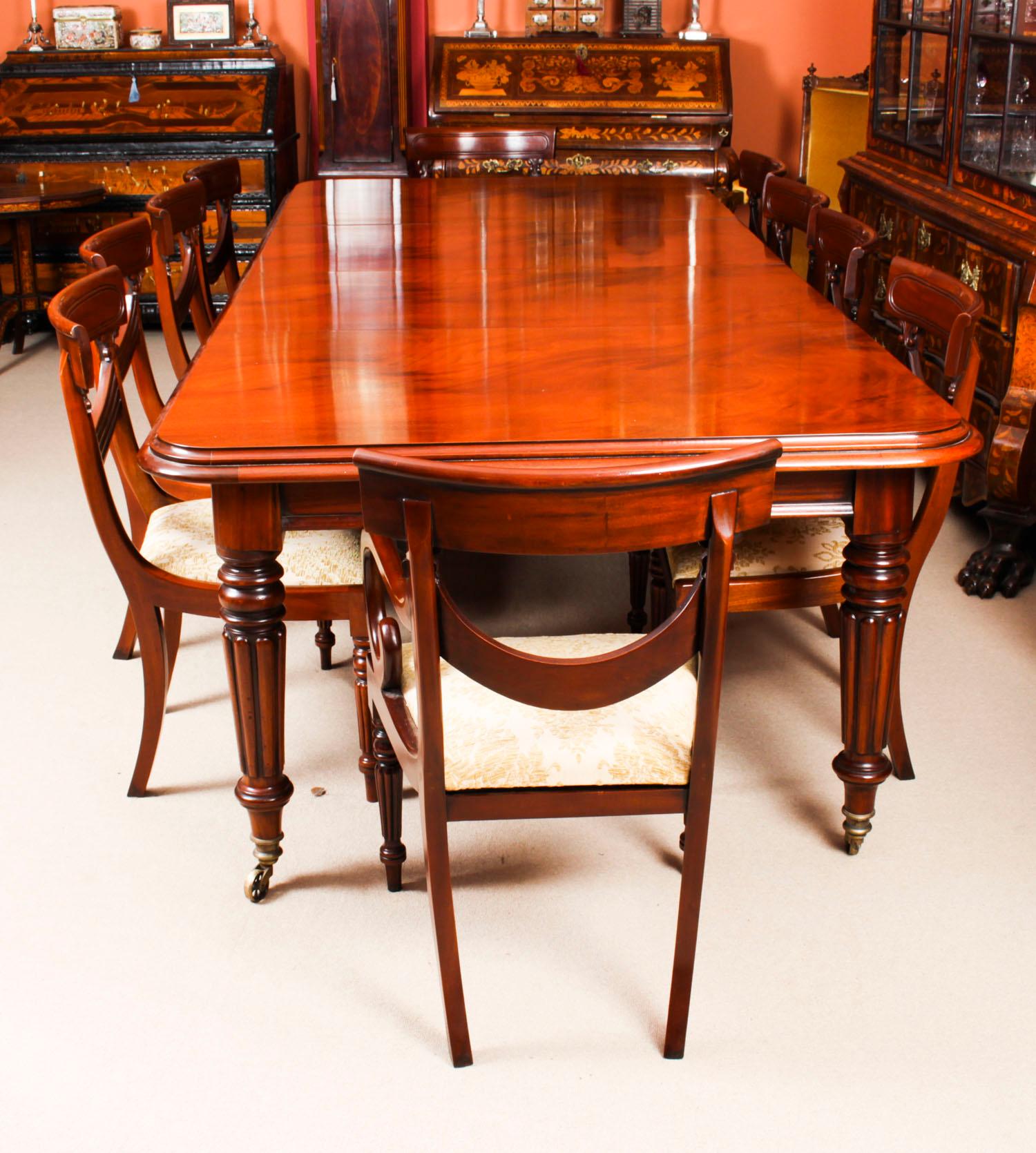 This is a superb dining set comprising a 14ft antique Regency Revival dining table, dating from the late 19th century, with a superb set of twelve Regency Period dining chairs dating from circa 1820.
The dining table is crafted in flame mahogany