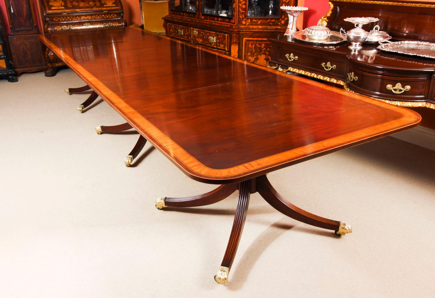 This is a superb dining set comprising a 14ft antique Regency Revival dining table, dating from the late 19th century, with a matching set of fourteen vintage dining chairs.
The dining table is crafted in flame mahogany and features superb