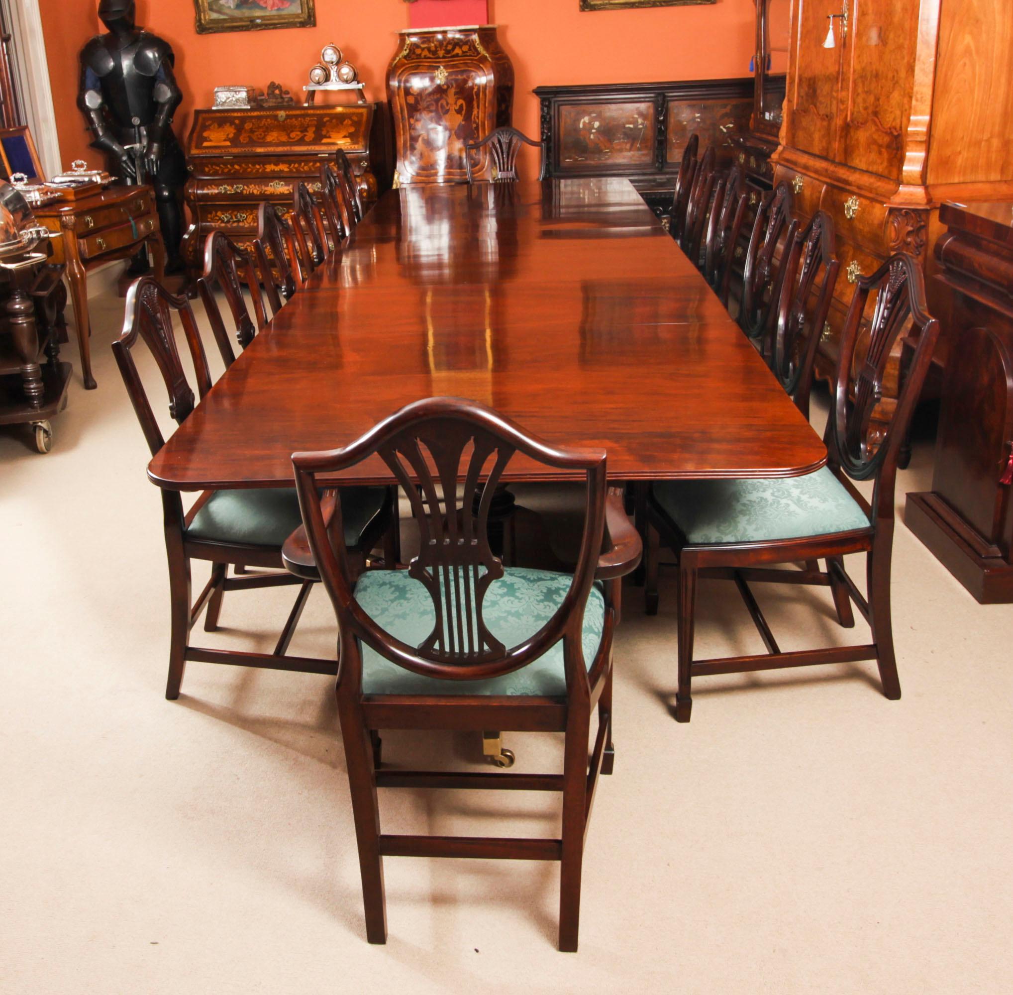 This is an elegant antique Regency Revival dining table, 19th Century in date and fourteen mid-century  wheatsheaf shieldback dining chairs.

The table has two leaves which can be added or removed as required to suit the occasion and it stands on
