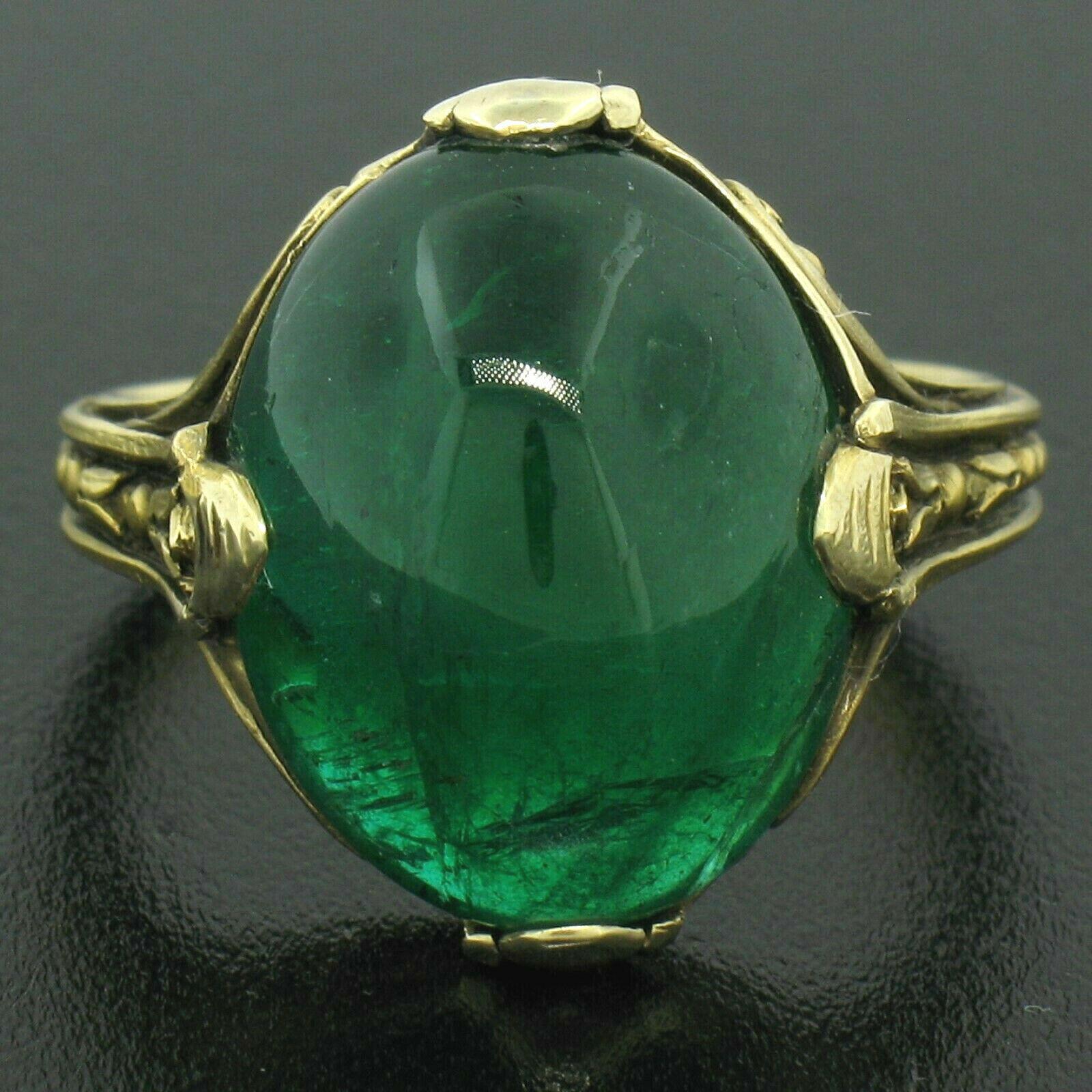 This truly unique, GIA certified, antique emerald solitaire ring was crafted in solid 14k yellow gold and features a breathtaking natural emerald with a deep and super rich green color. The stone is perfectly prong set in a beautifully hand etched