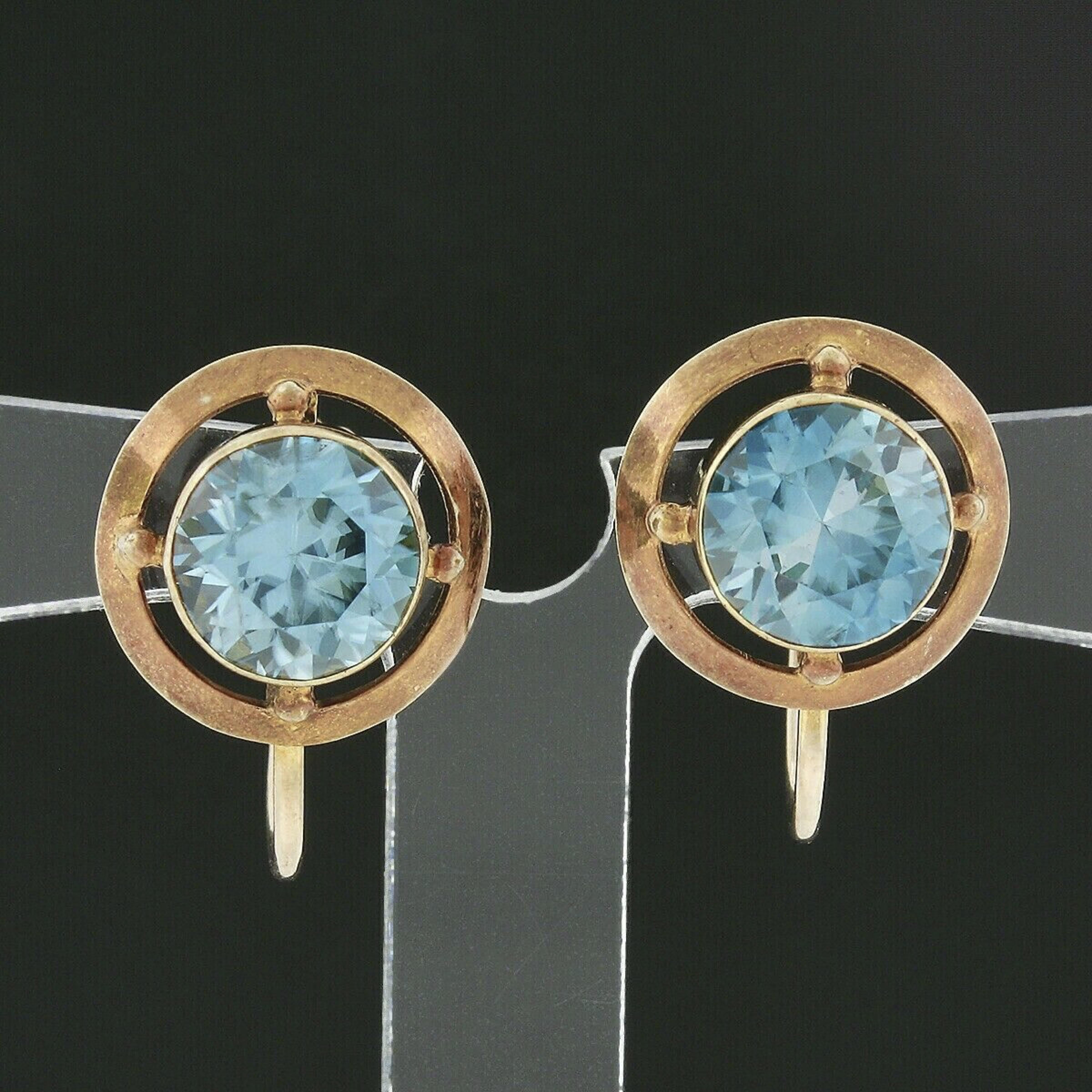 This superb pair of antique earrings was crafted from solid 14k yellow gold and feature a gorgeous blue zircon neatly bezel set at their center. These old round cut stones display a nice large size, totaling approximately 5 carats in weight, and