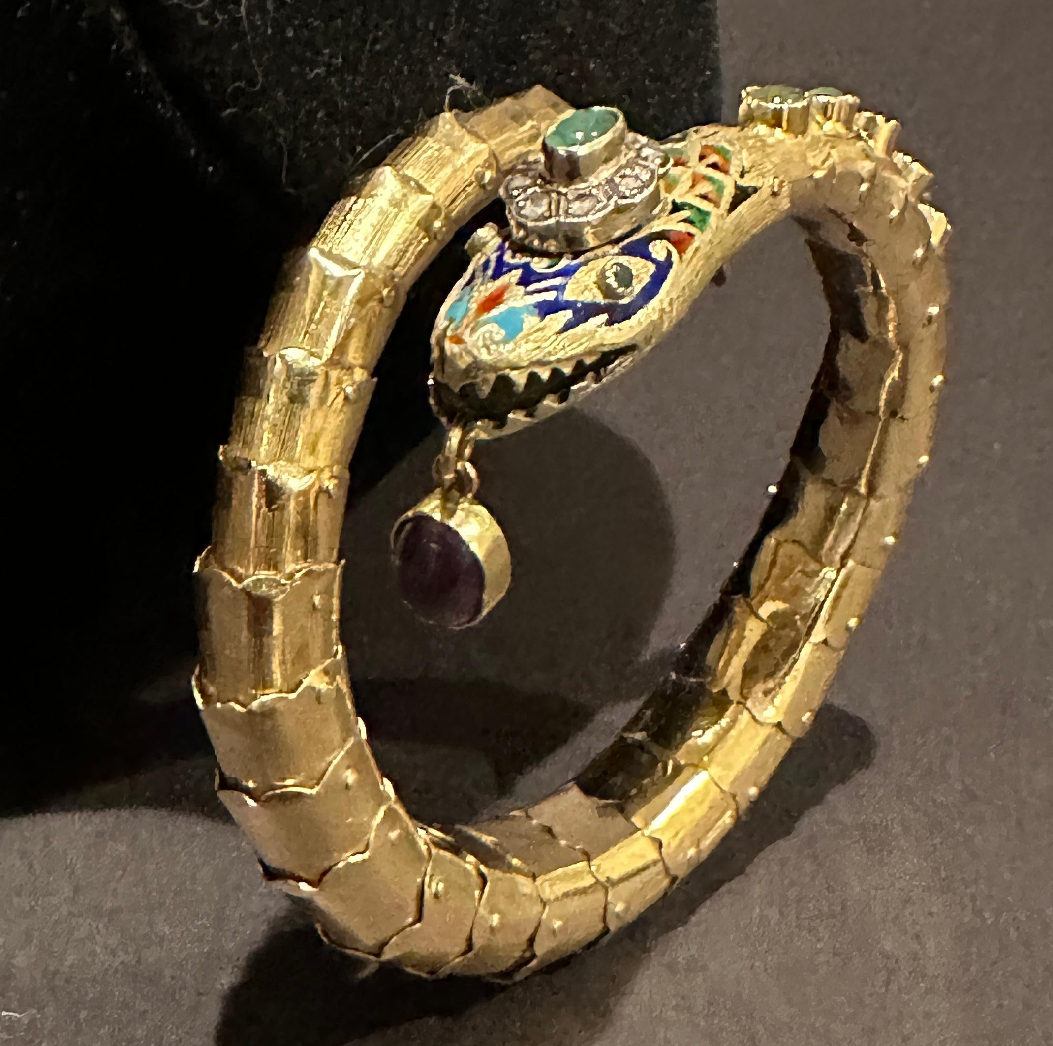 Art Deco 14k gold, diamond, Jade and amethyst enameled and  articulated bracelet in the form of a snake. 8 rose cut diamonds. Jade and amethyst cabochons  with multicolored enamel. 40.3 grams total weight. Minor area of interior spring protrusion at