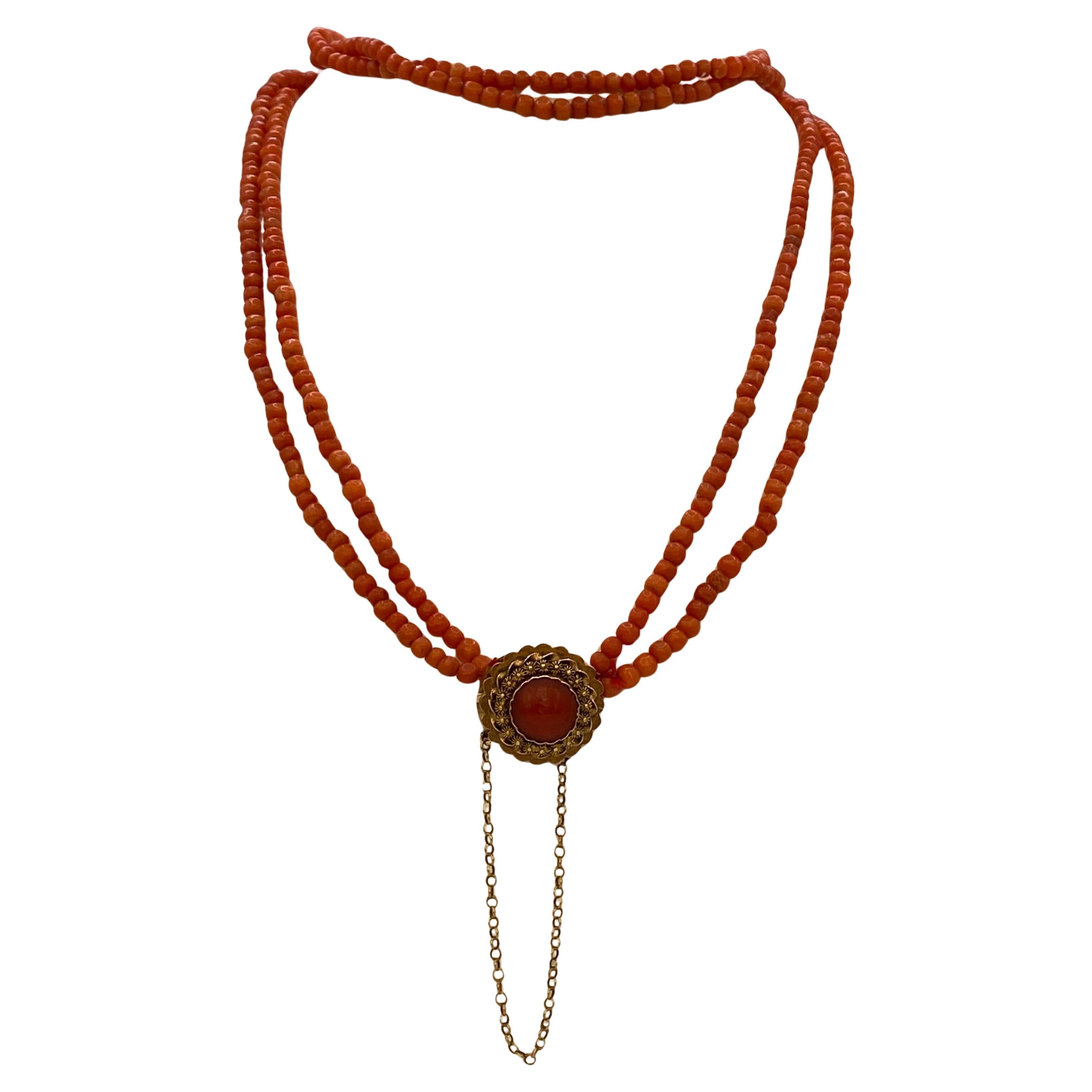 This antique late 19th century blood  coral necklace is created with 14 karat gold clasp a filigree work, and set with cabochon blood coral approx.10mm.  The clasp has additional chain for safety.  The beautiful two rows-strand coral necklace is