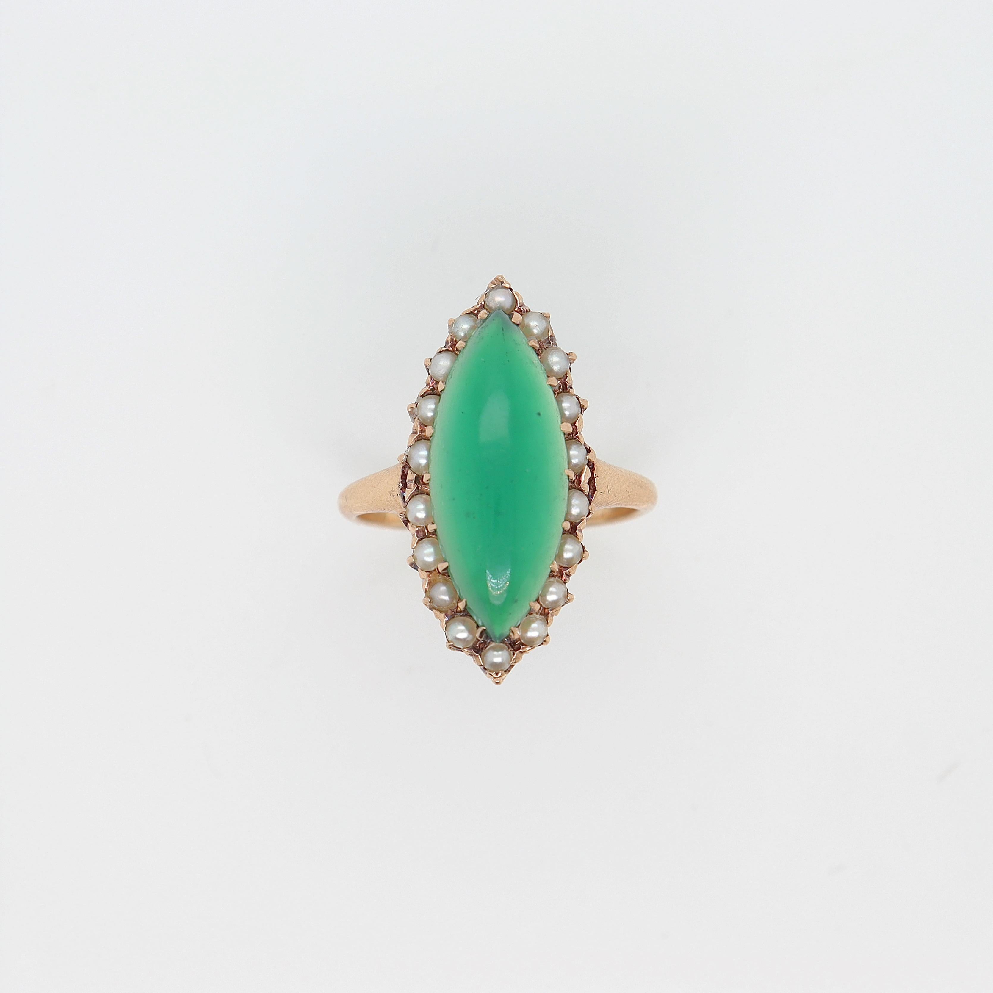 A fine antique gold, chrysoprase, and seed pearl ring.

In 14K gold.

With a navette shaped chrysoprase cabochon high set above a halo of small prong set seed pearls.

Simply a wonderful ring!

Date:
Early to Mid 20th Century

Overall Condition:
It