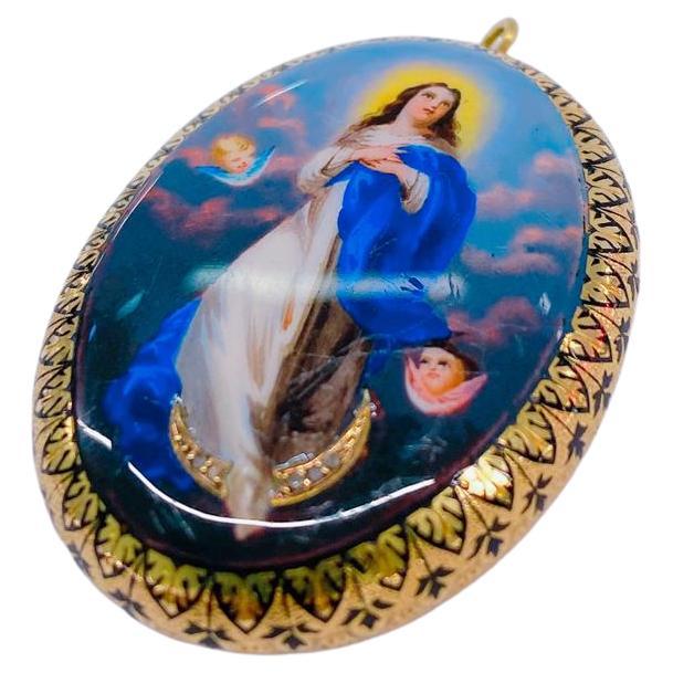 Antique locket pendant hand painted in colourful enamel portrait of virgin mary and angels with total gold weight of 8.65 grams and lenght of 4cm pendant was made in europ 1900.c enamel in good condition rare piece of antique jewelry