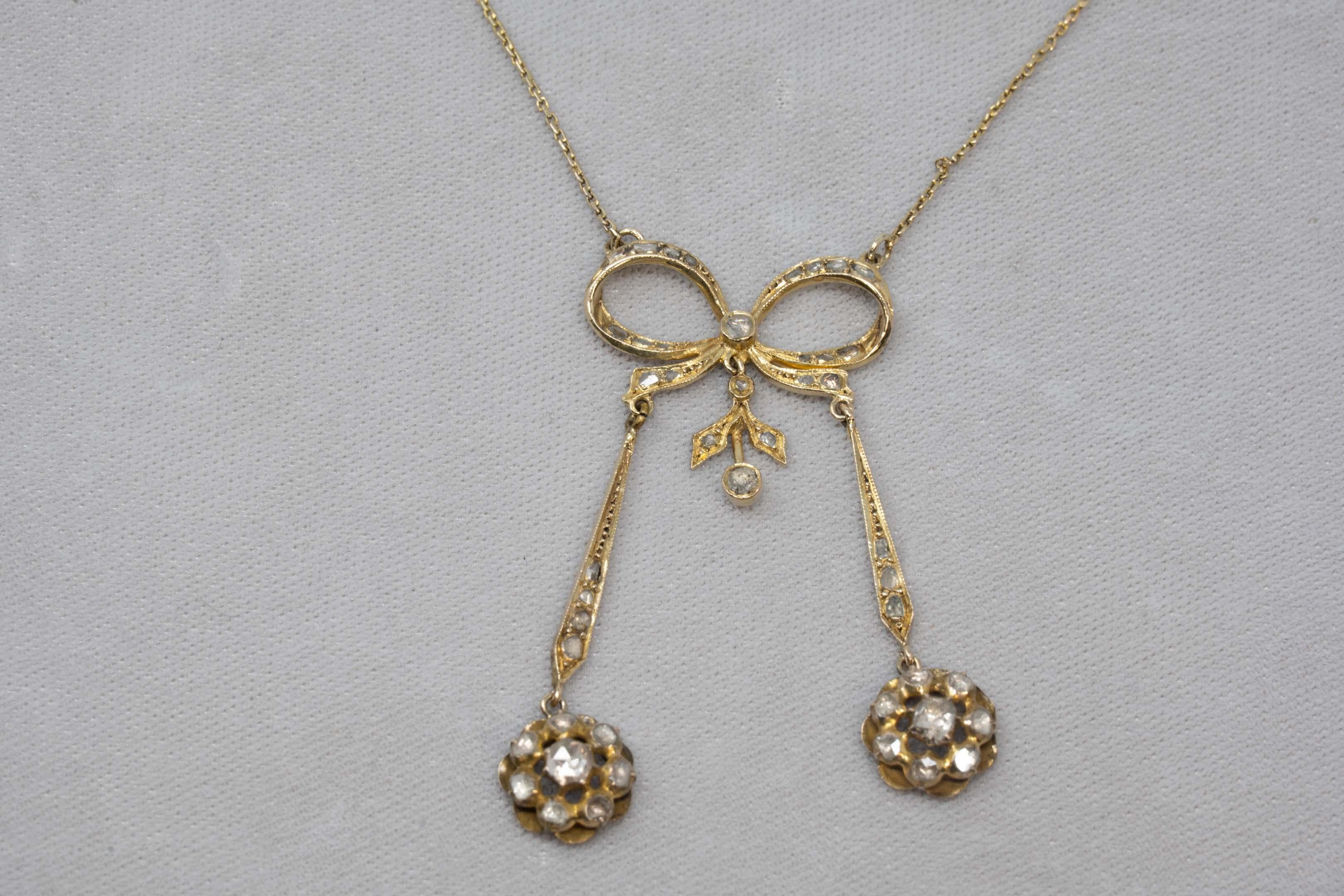 14k gold necklace set with 47 mine cut diamonds, stamped on the lock and acid tested. The chain measures 14 inches long and the buckle pendant measures 2 1/4 inches circa 1900. Weighs 11.4 grams.