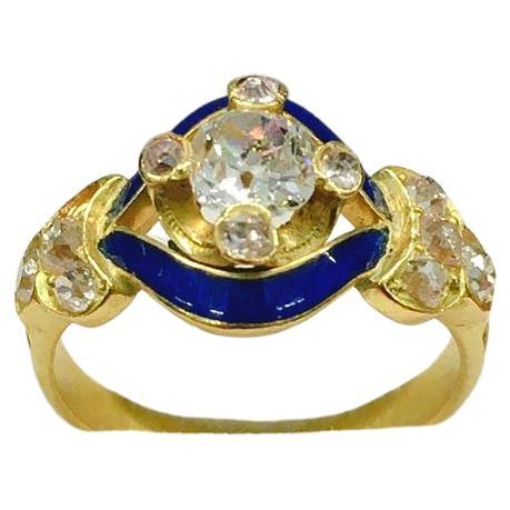 Antique solitare ring centered with old mine cut diamond estimate weight of 0.60 ct H color si clearity flanked with smaller old cut diamonds with estimate weight of 0.80 ct decortred with blue enamel in excellent condition ring was made in europe