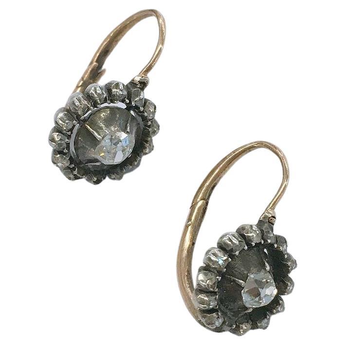 Antique 14k gold earrings topped with silver in circular setting shape with 1 old mine cut diamond estimate weight of 0.50 carat each earring H  colour white exceelent spark earrings dates back to 1880/1900.c