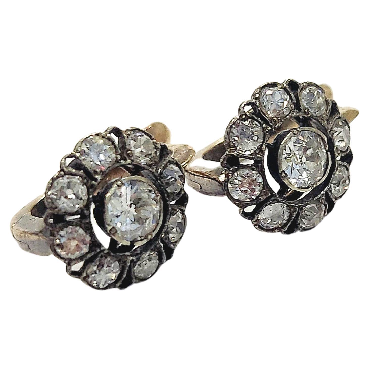 Antique 14k gold earrings centered with old mine cut diamond flanked with smaller old mine cut diamonds with total estimate weight of 1.5 carats H color white excellent spark earrings dates back to the russian tsarist era 1910/1917.c hall marked 56