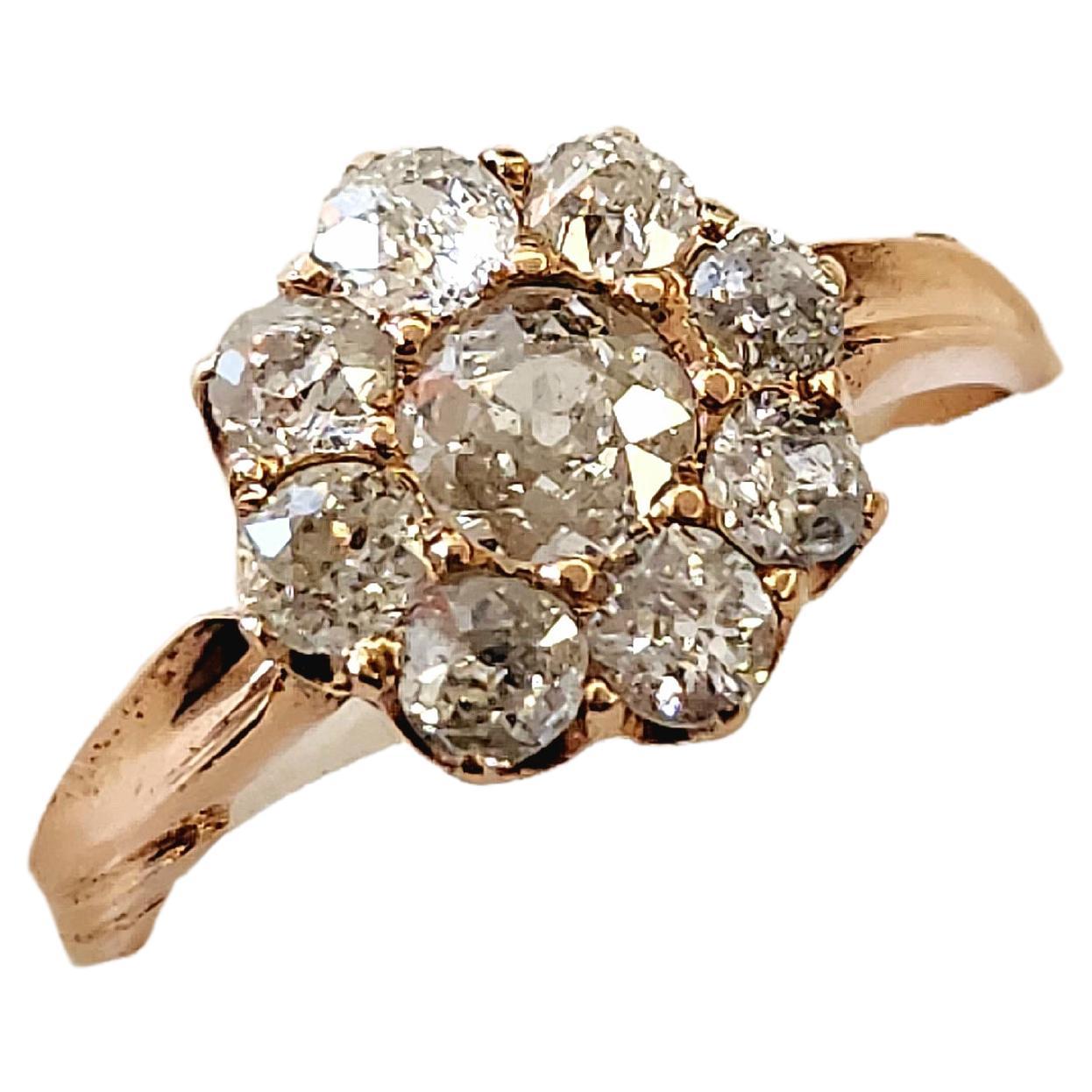 Antique 14k gold old mine cut diamond ring in floral head designe with estimate diamond weight of 1.4 carats H colour vs clearity centered with large old mine cut diamond flanked with smaller diamonds in detailed work on ring setting and total gold