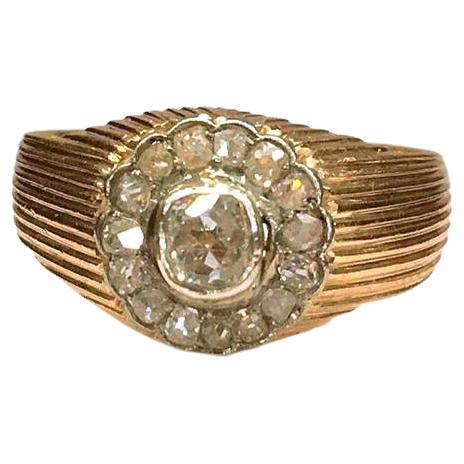 Antique russian 14k ring centered with 1 old mine cut diamond with an estimate weight of 0.75 ct flanked with smaller diamonds in engraved workmanship detailed ring setting ring hall marked 56 gold standard and assayer initial mark 