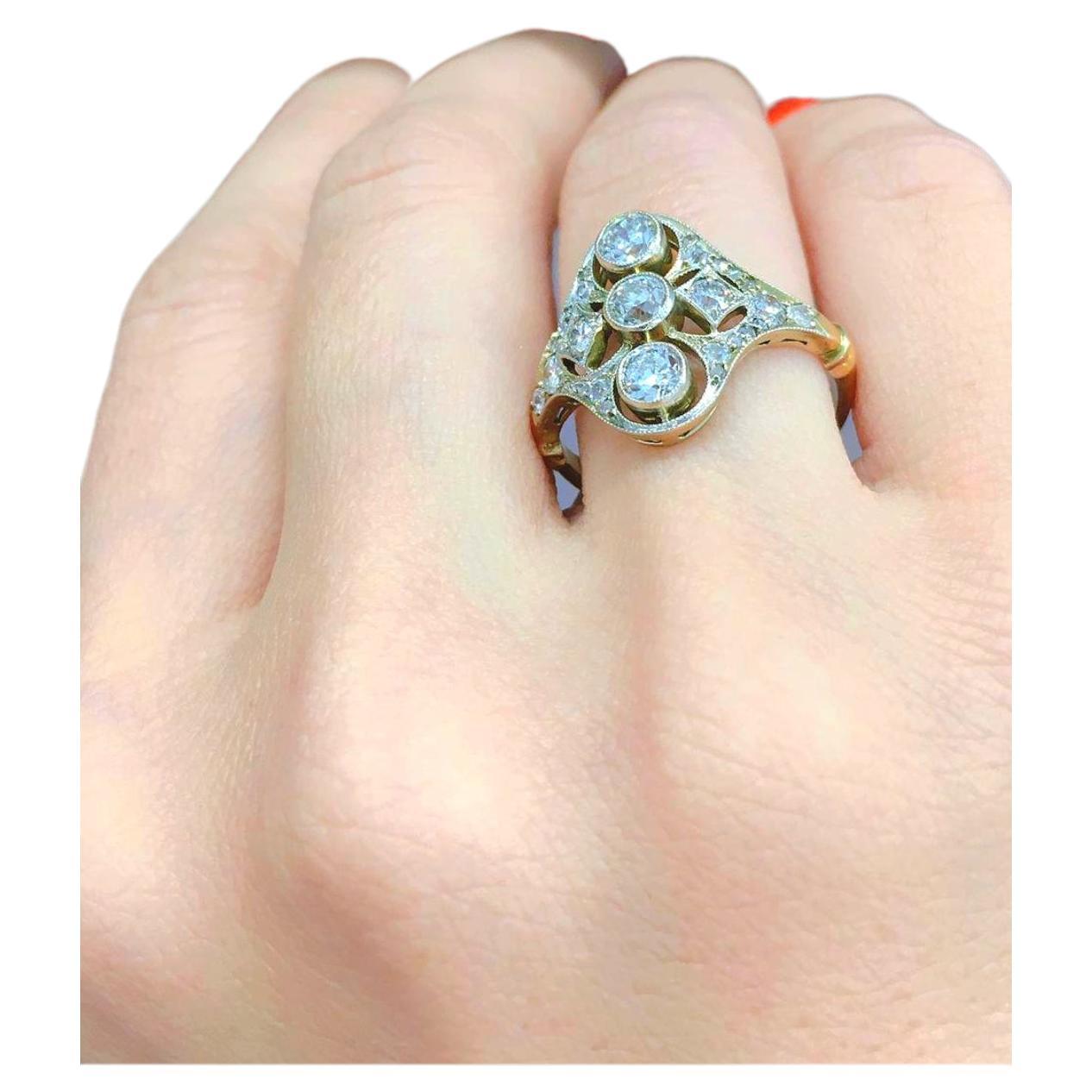 Antique 14k gold ring in geometric open work style centered with 3 large old mine cut diamonds flanked with smaller old mine cut diamonds with total estimate weight of 1.5 carats H/i color inclousions included 