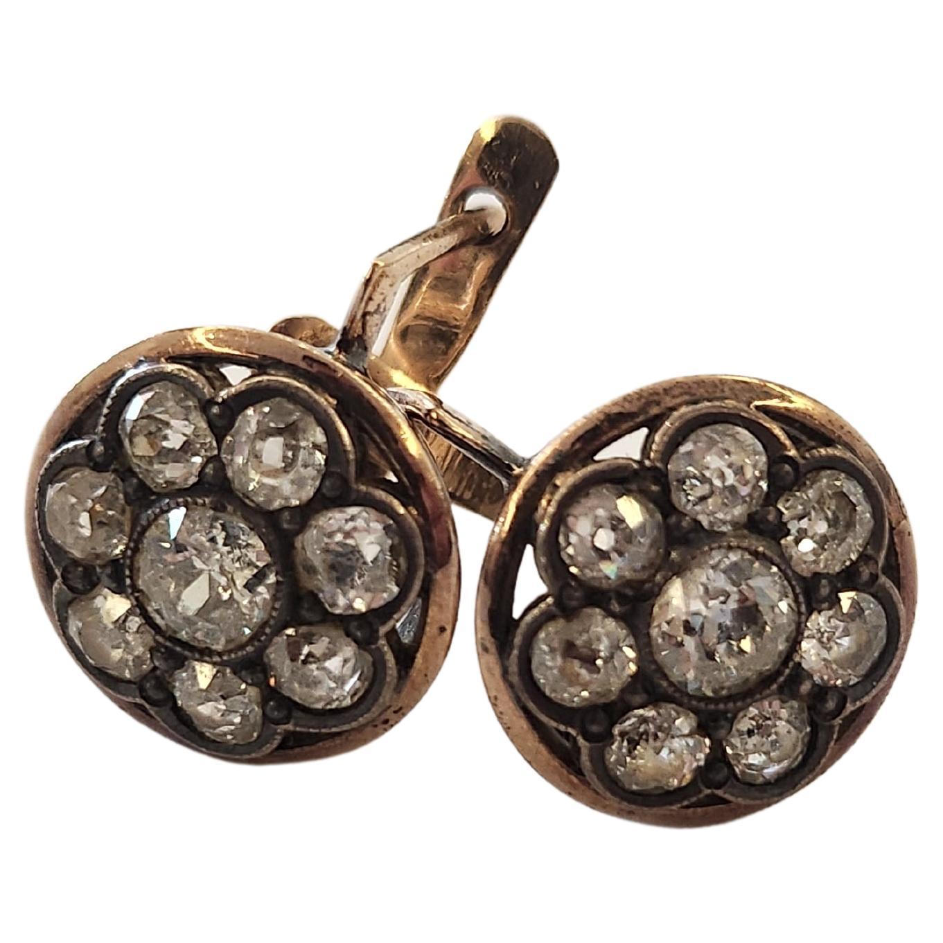 Old mine diamond earrings in round circled designe in 14k gold setting topped with silver with estimate old mine cut diamonds weight of 1.80 carats centered with larger diamond flanked with smaller diamonds earrings was made during the early soviet