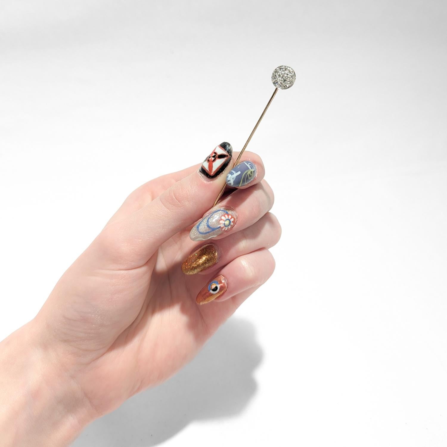 A fine antique gold stickpin.

In 14 karat yellow gold.

Pave set with Old European Cut Diamonds.

This stickpin is likely a conversion.

Simply a wonderful stickpin!

Date:
20th Century

Overall Condition:
It is in overall good, as-pictured, used
