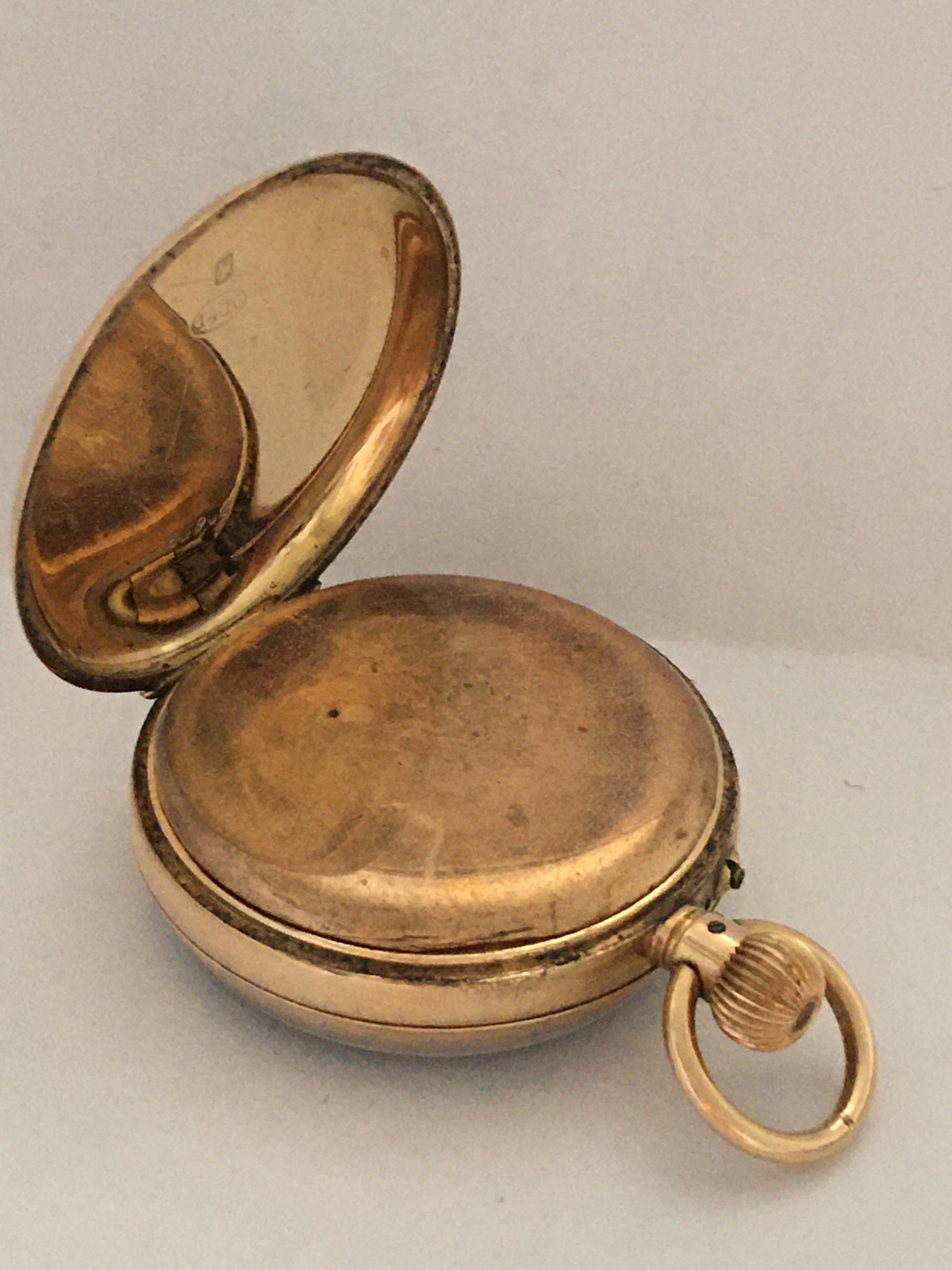 small gold pocket watch