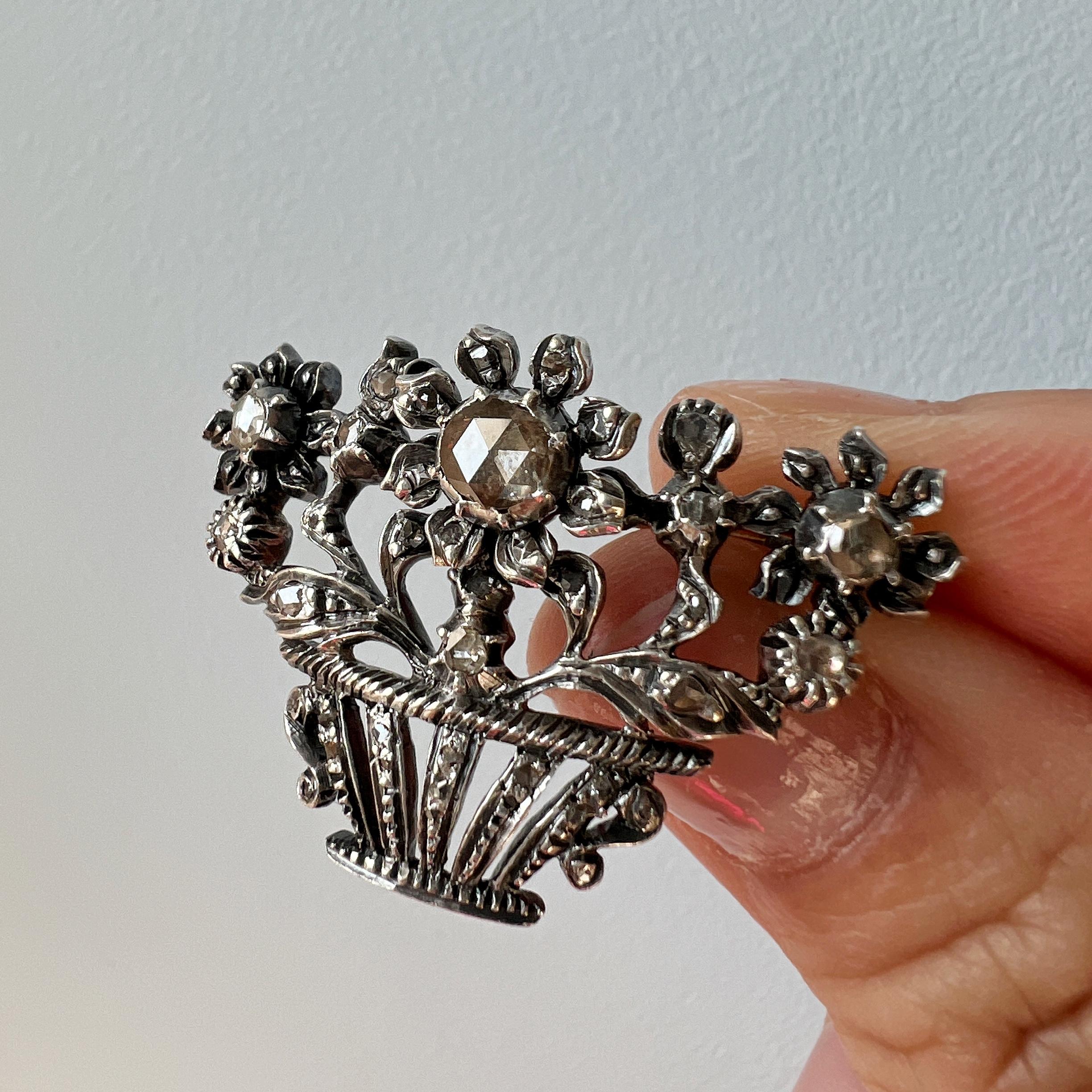 For sale a beautiful flower basket diamond brooch, with a definite nod to the romanticism of a bygone era.

The brooch combines rose cut diamonds with an enchanting floral design. The biggest rose cut diamond on the flower measures 6mm in diameter