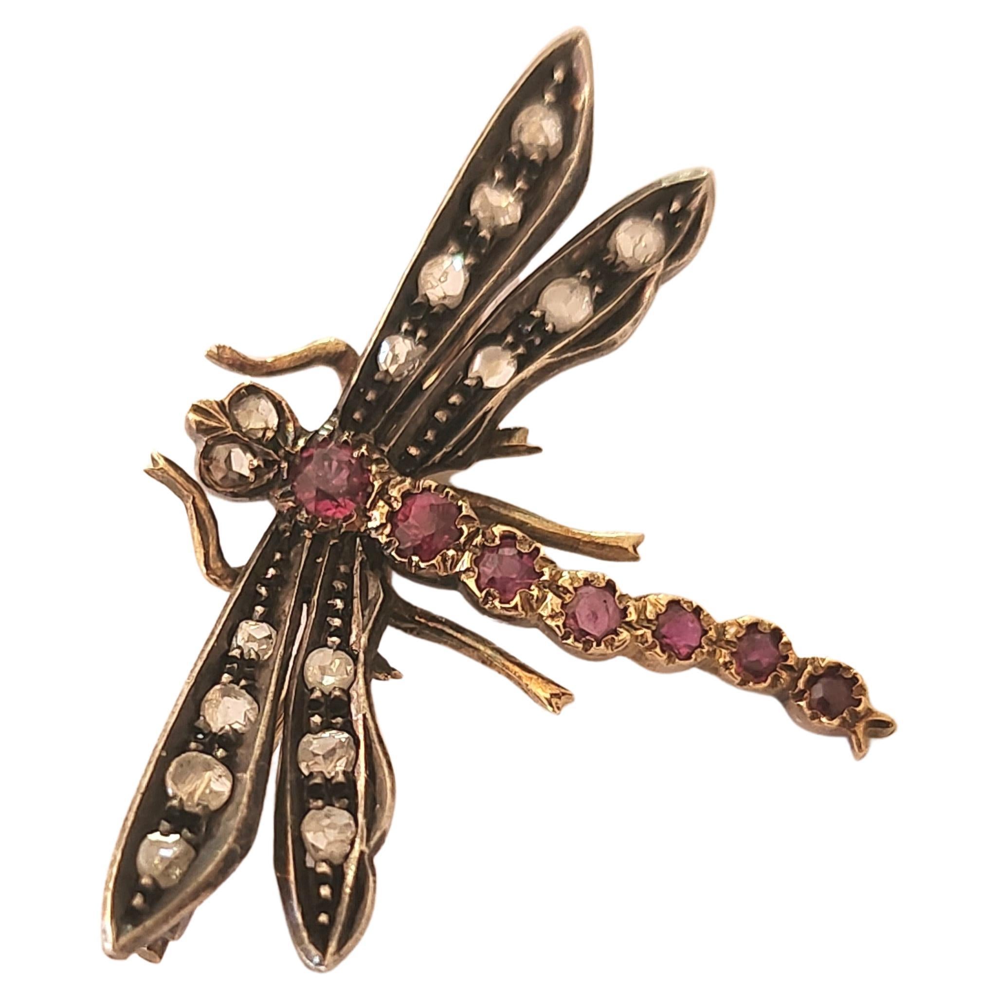 Antique brooch in dragon fly designe with natural pigioun blood ruby colour on tail and rose cut diamonds on wings brooch lenght is 2.5 cm hall marked with initial maker mark 