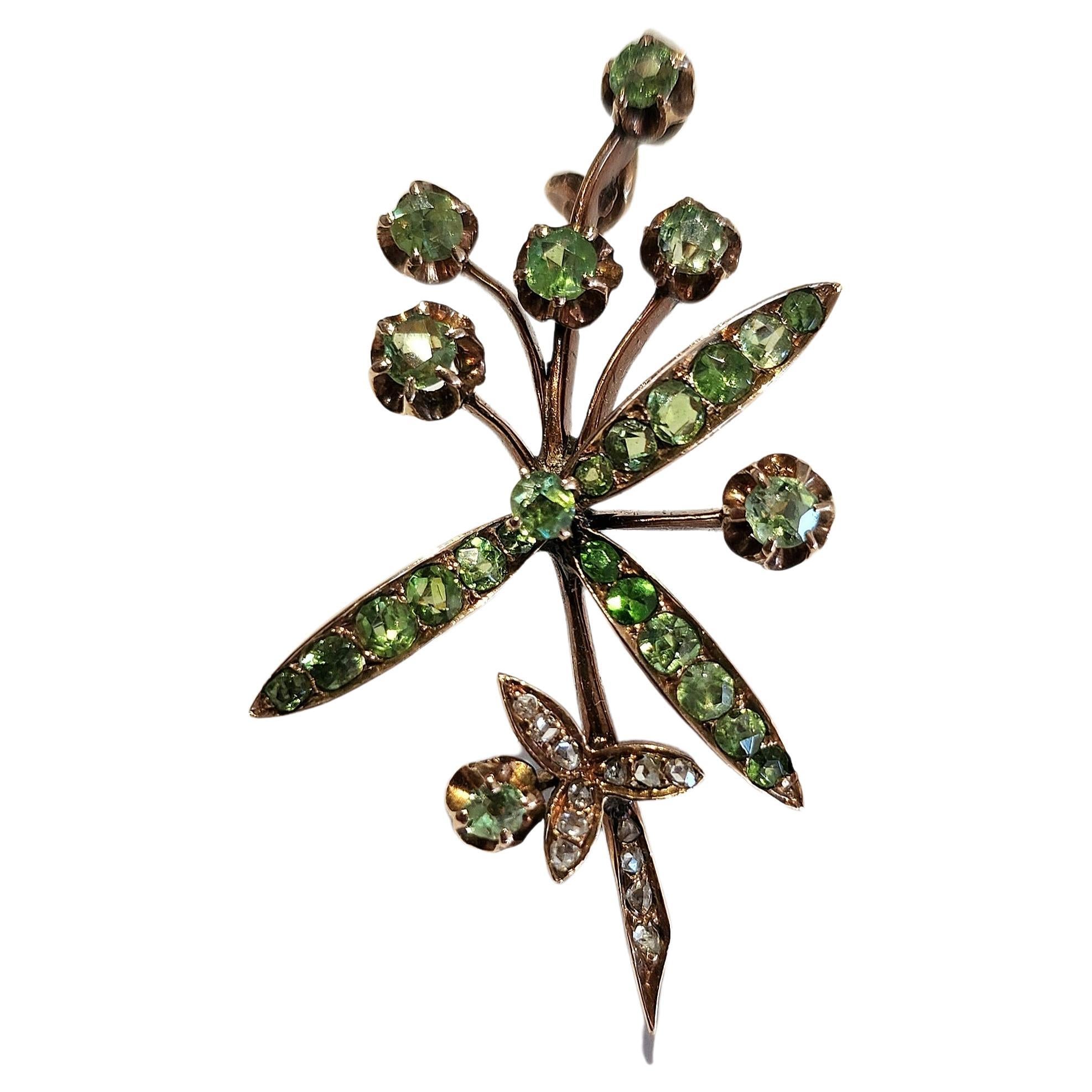 Antique 14k gold brooch with russian green demantoid stones Excellent fire spark in tremplant designe brooch was made in moscow 1916/1920.c with total lenght of 4.5cm hall marked 583 for 14k gold and moscow assay mark and initial maker mark