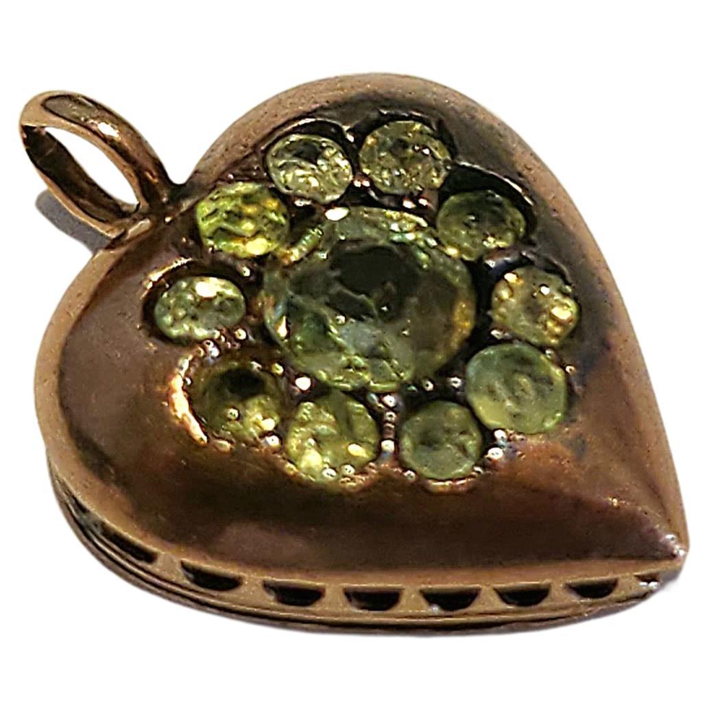 Antique heart locket pendant with russian green demantoid centered with a larger demantoid 4.35mm flanked with smaller demantoid stones pendant lenght 1.5cm was made in moscow 1907/1910.c hall marked 56 imperial russian gold standard and moscow