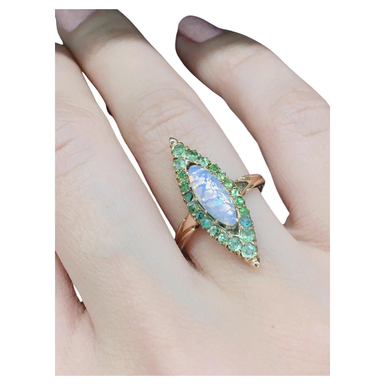 Antique russian ring in navviet style centered with a natural opal stone in marques cut flanked with green demantoid stones in 14k gold setting ring was made in st petersburg 1907/1910.c imperial russian era hall marked 56 imperial russian gold