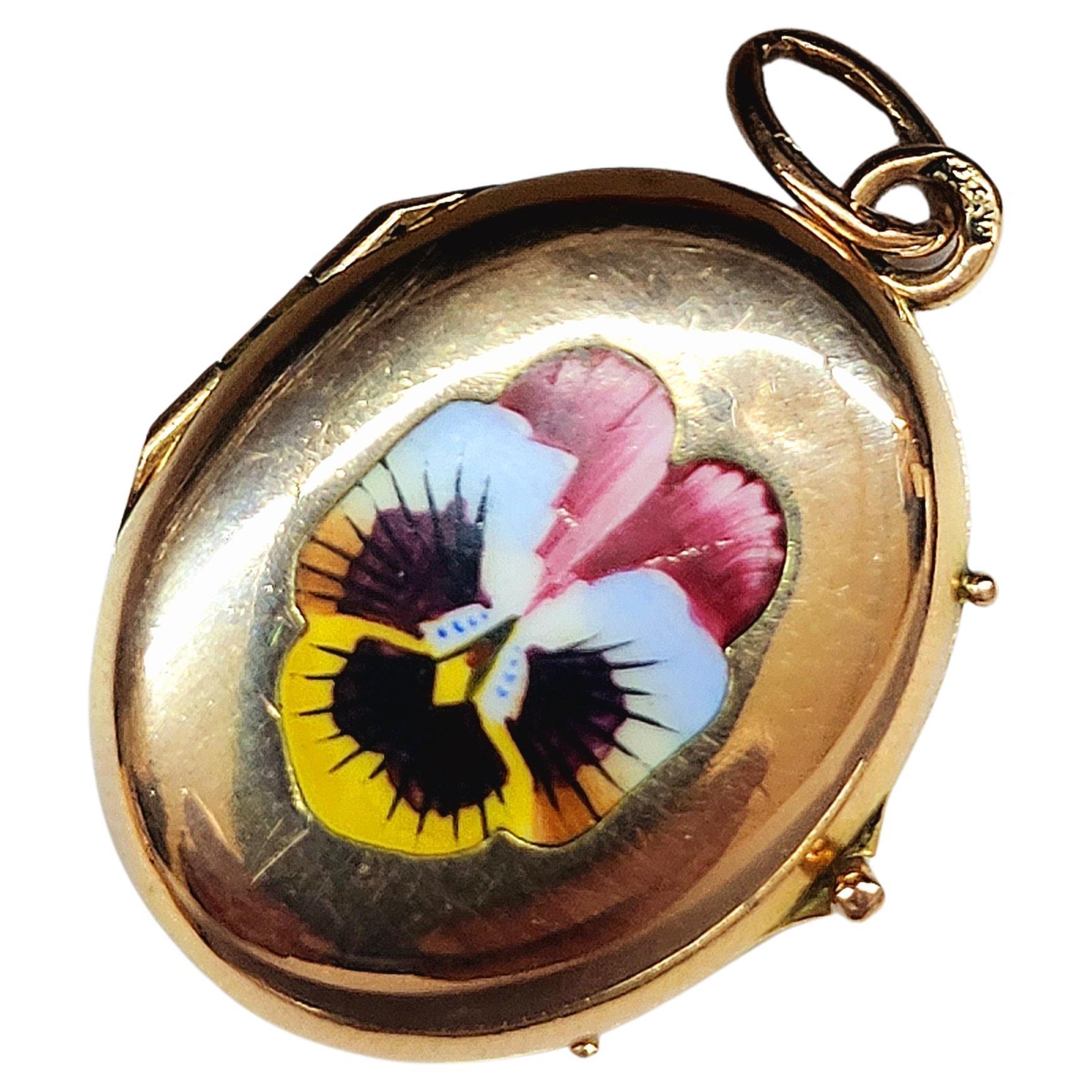 Antique 14k gold russian locket pendant with enamel hand painted on front of a flower pendant was made during the imperial russian era 1907/1917.c hall marked 56 imperial russian gold standard and assay mark with total pendant lenght 3.5cm 