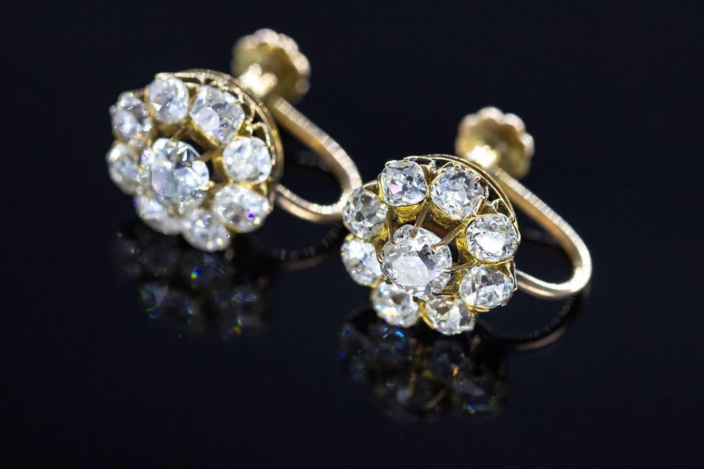 Antique earring in floral shape with old mine cut diamonds centered with 1 larger old mine diamond , flanked with smaller diamonds with estimate total weight of 4 carats H color white excellent spark earrings was made in middle of 20th century (