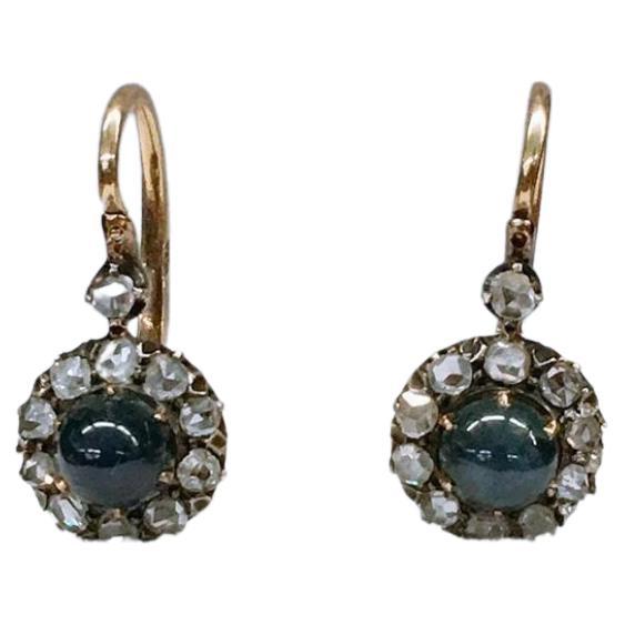 Antique 14k gold earrings centered with natural cobouchon blue sapphire flanked with rose cut diamonds earrings was made in st peatersburg during the imperial russian era 1907/1917.c hall marked 56 imperial russian gold standard and assayer initial