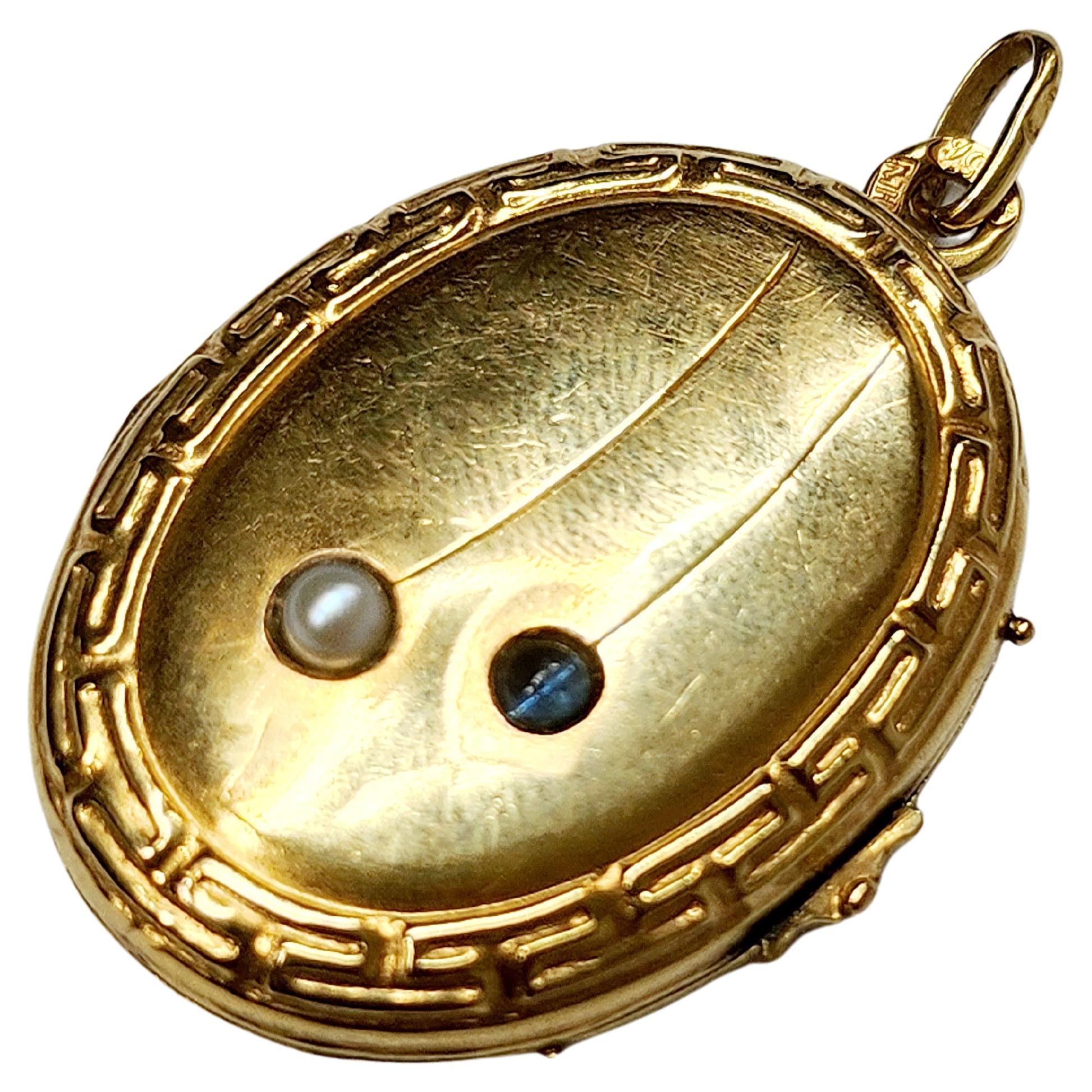 Antique 14k gold russian locket pendant centered with 1 natural blue sapphire stone and white pearl with total gold weight of 5 grams and 4cm lenght in detailed workmanship pendant was made in odessa durung the imperial russian era 1907.c hall