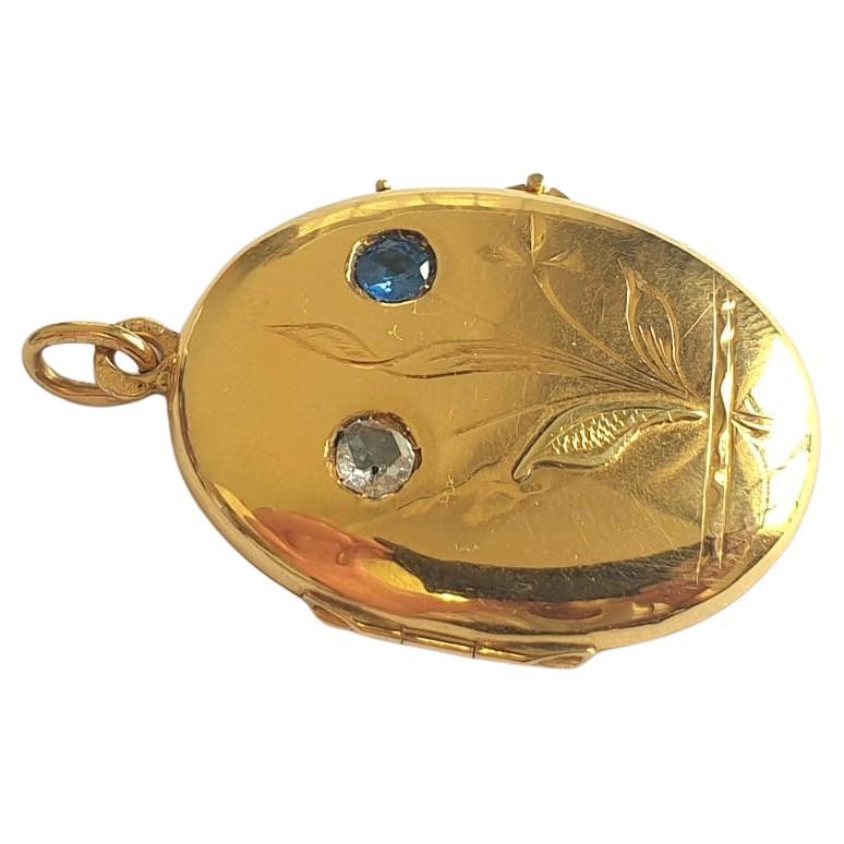 Antique 14k gold locket pendant centered with blue sapphire and rose cut diamond with engraved work on front locket dates back to the imperial russian era hall marked 56 imperial russian gold standard and initial maker mark