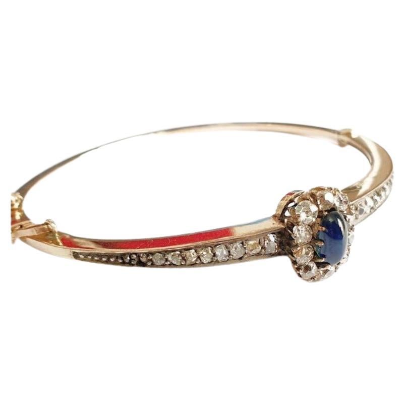 Antique 14k gold russian cuff braclete centered with 1 blue cabochon blue sapphore  flanked with rose cut diamonds with estimate weight of 1.5 carats braclete dates back to the imperial russian era 1899/1904.c hall marked 56 imperial russian gold