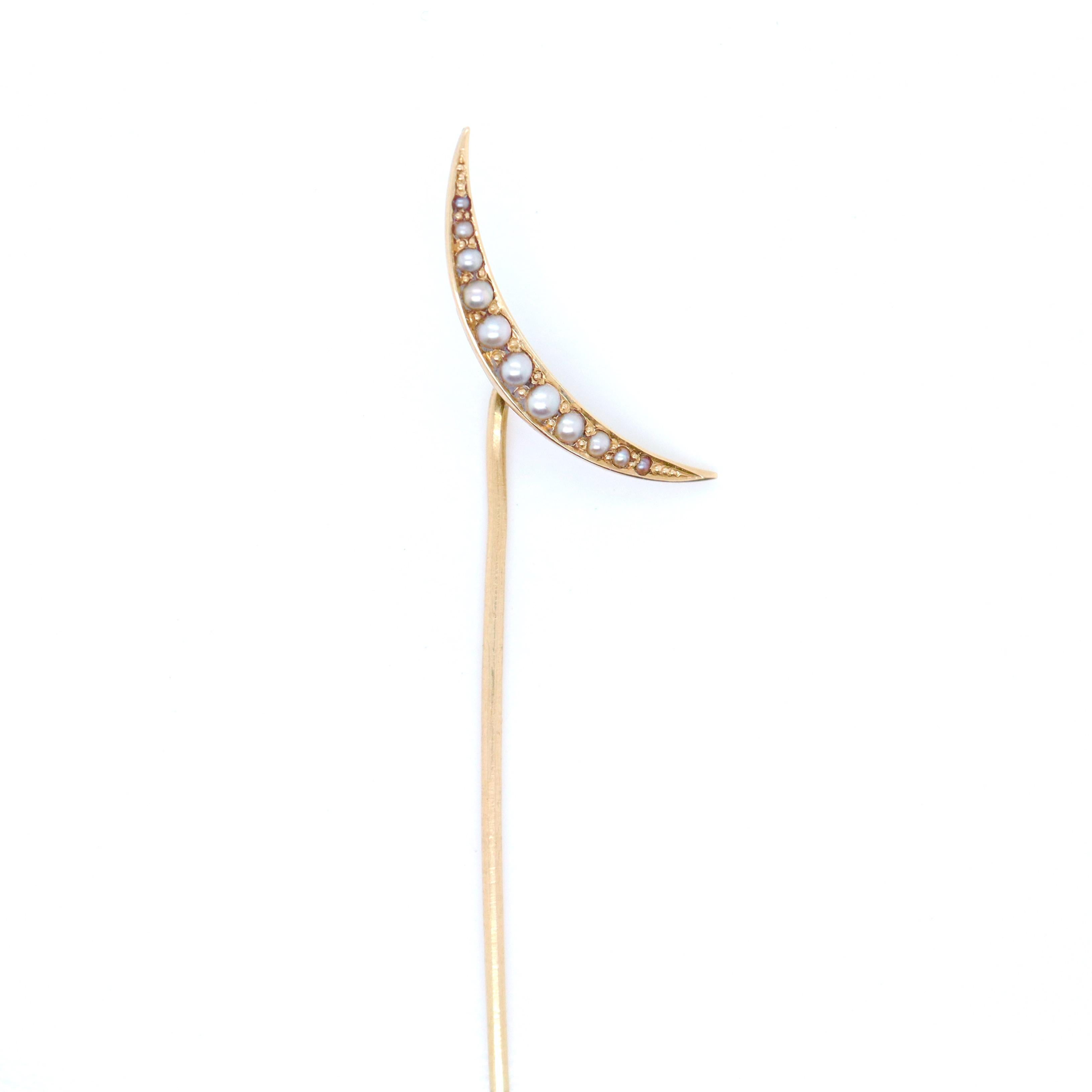 A fine antique gold and pearl pin.

In the form of a crescent moon.

In 14k gold.

Set with 10 small seed pearls.

Marked to the reverse with a cross maker's mark.

Simply a wonderful stick pin!

Date:
20th Century

Overall Condition:
It is in