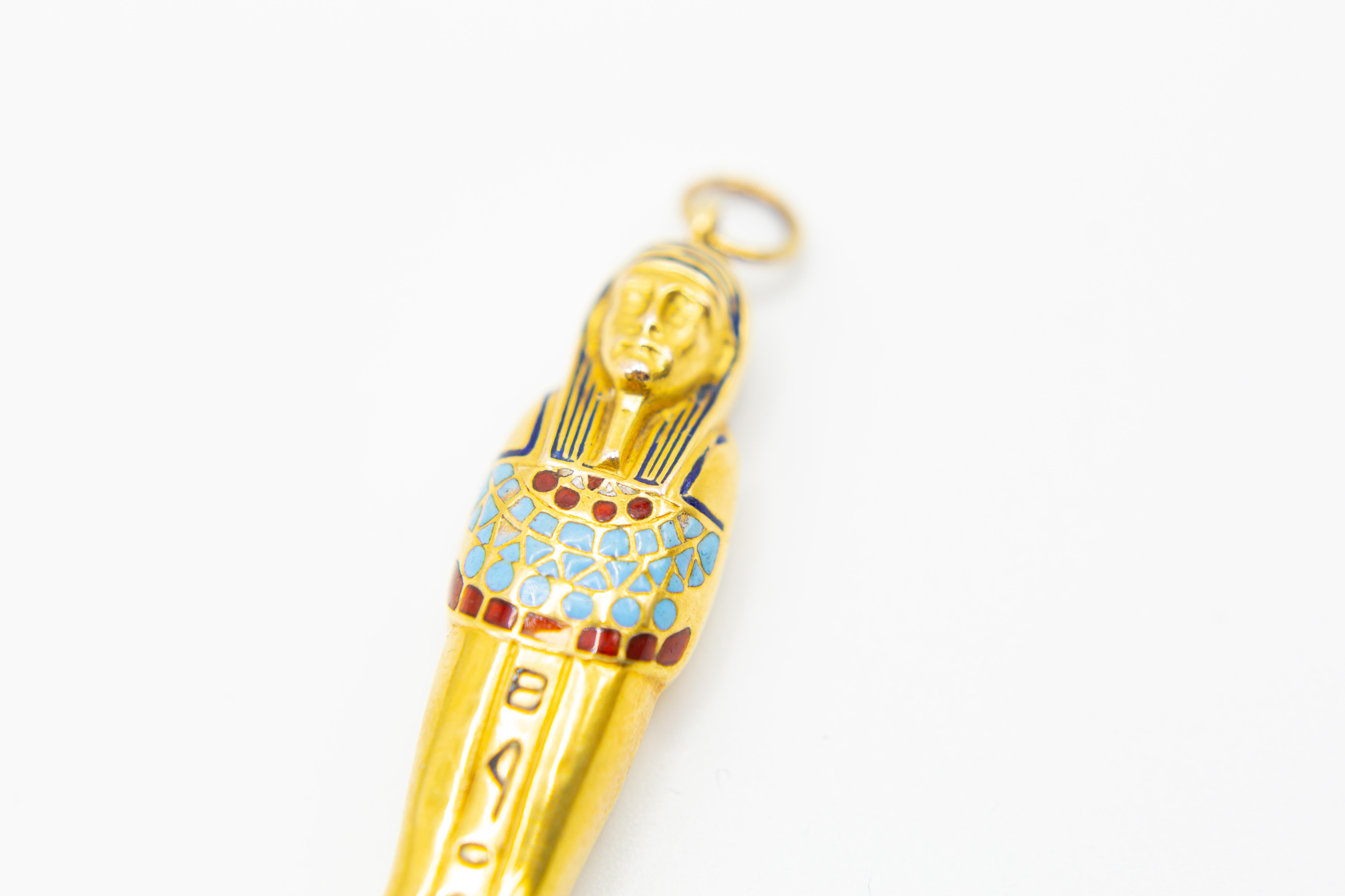 Antique 14k gold and enameled propelling pencil Egyptian mummy from the 20th century. The pencil is 7.2cm long. It has a bit of enamel loss. It weighs 15.04g