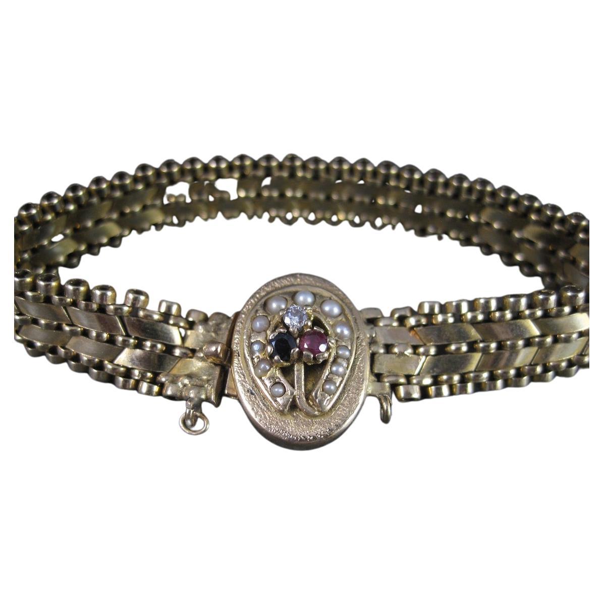 Bracelet ancien fer à cheval en or 14 carats avec saphirs, rubis et perles de rocaille
